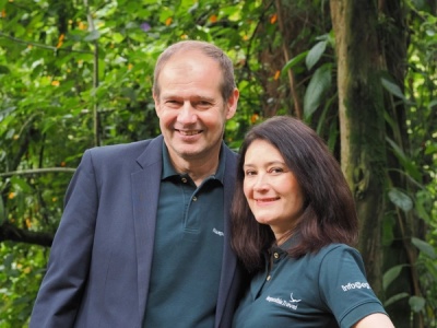 A man and a woman smiling in the jungle