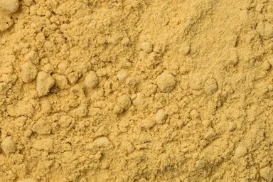 A close-up of Full Fat Oriental Mustard Flour, showcasing its fine texture and deep, rich color.