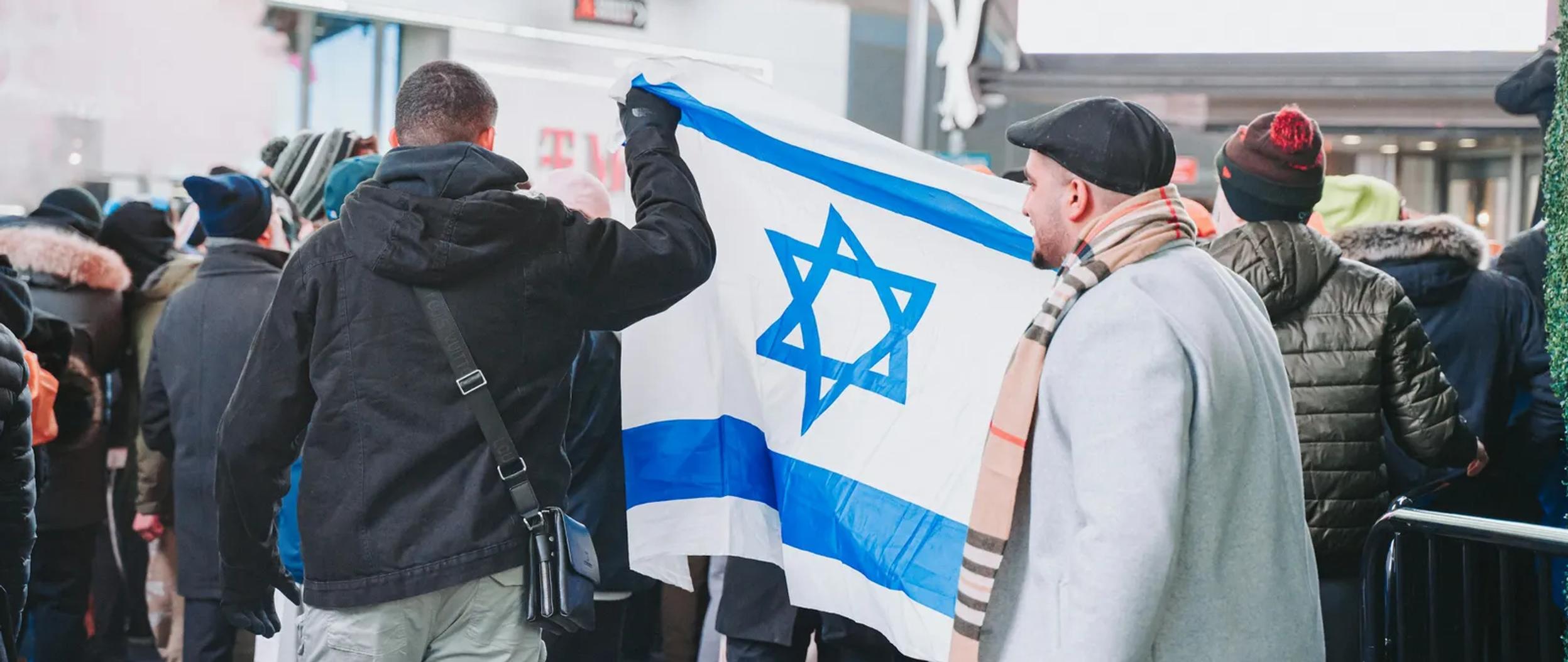 Procession of people carrying the Israeli flag