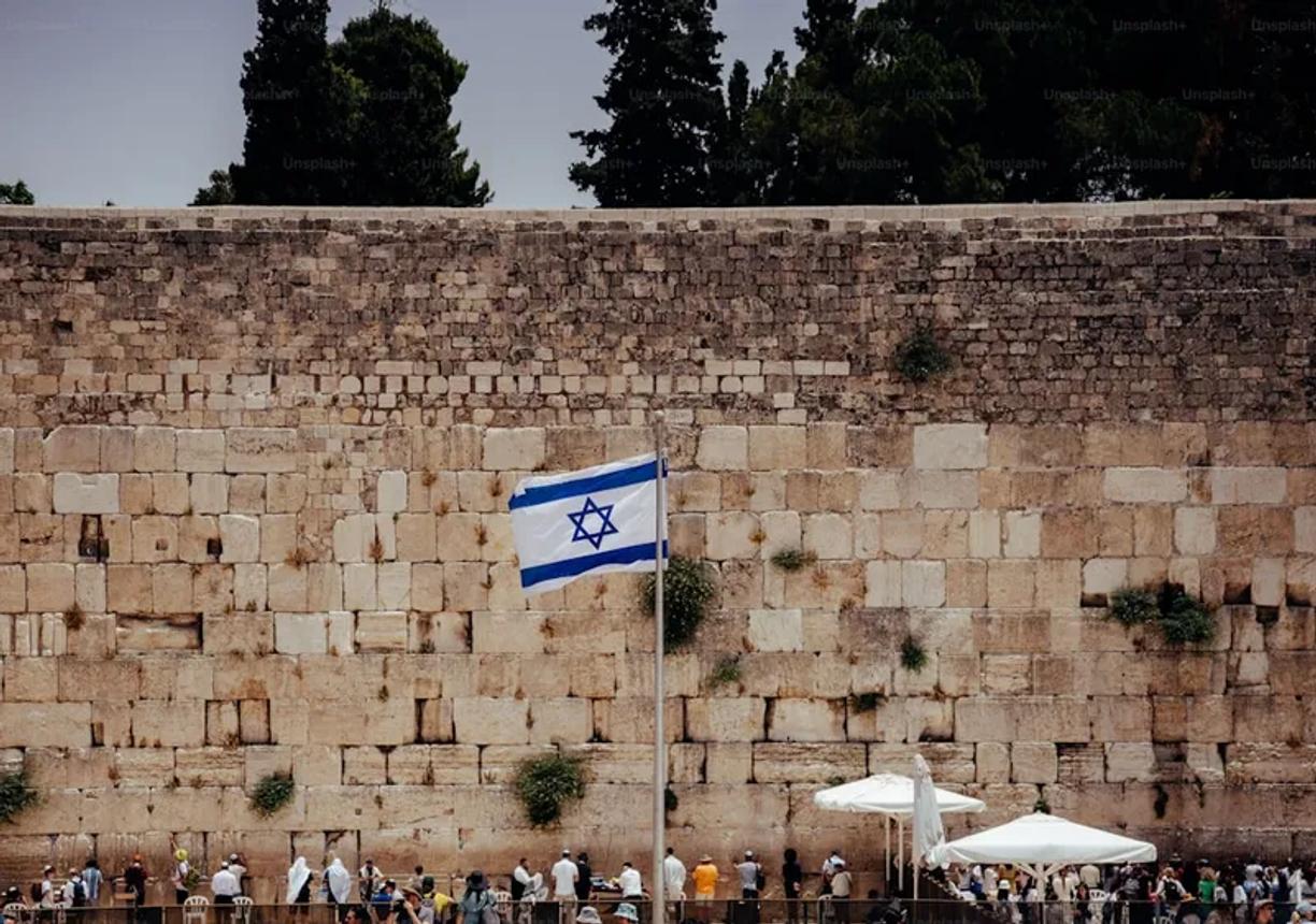 The Western Wall in Jerusalem with the Israeli flag flying