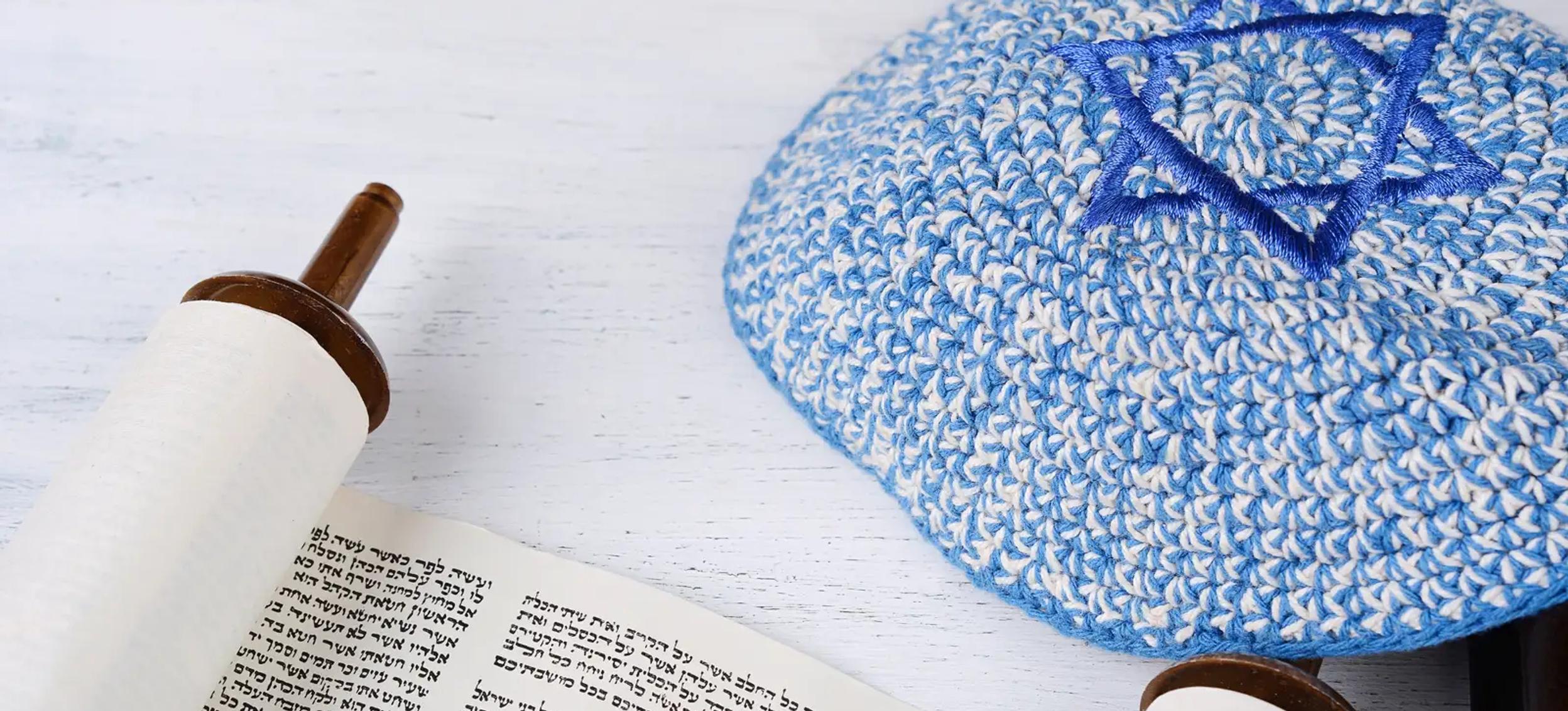 Torah scroll beside a kippah with a Star of David