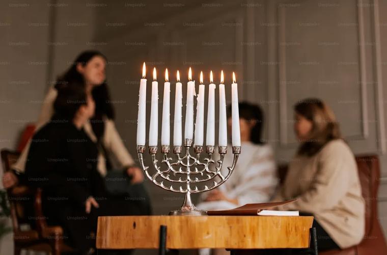 A set Shabbat table with candles and challah