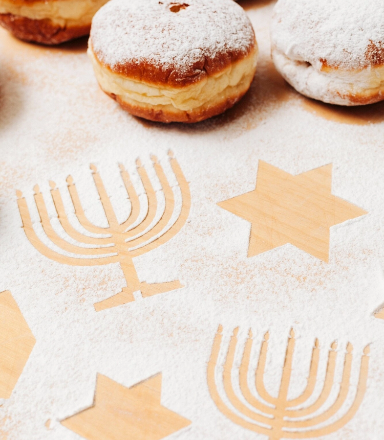 A Shabbat table with bread and a menorah