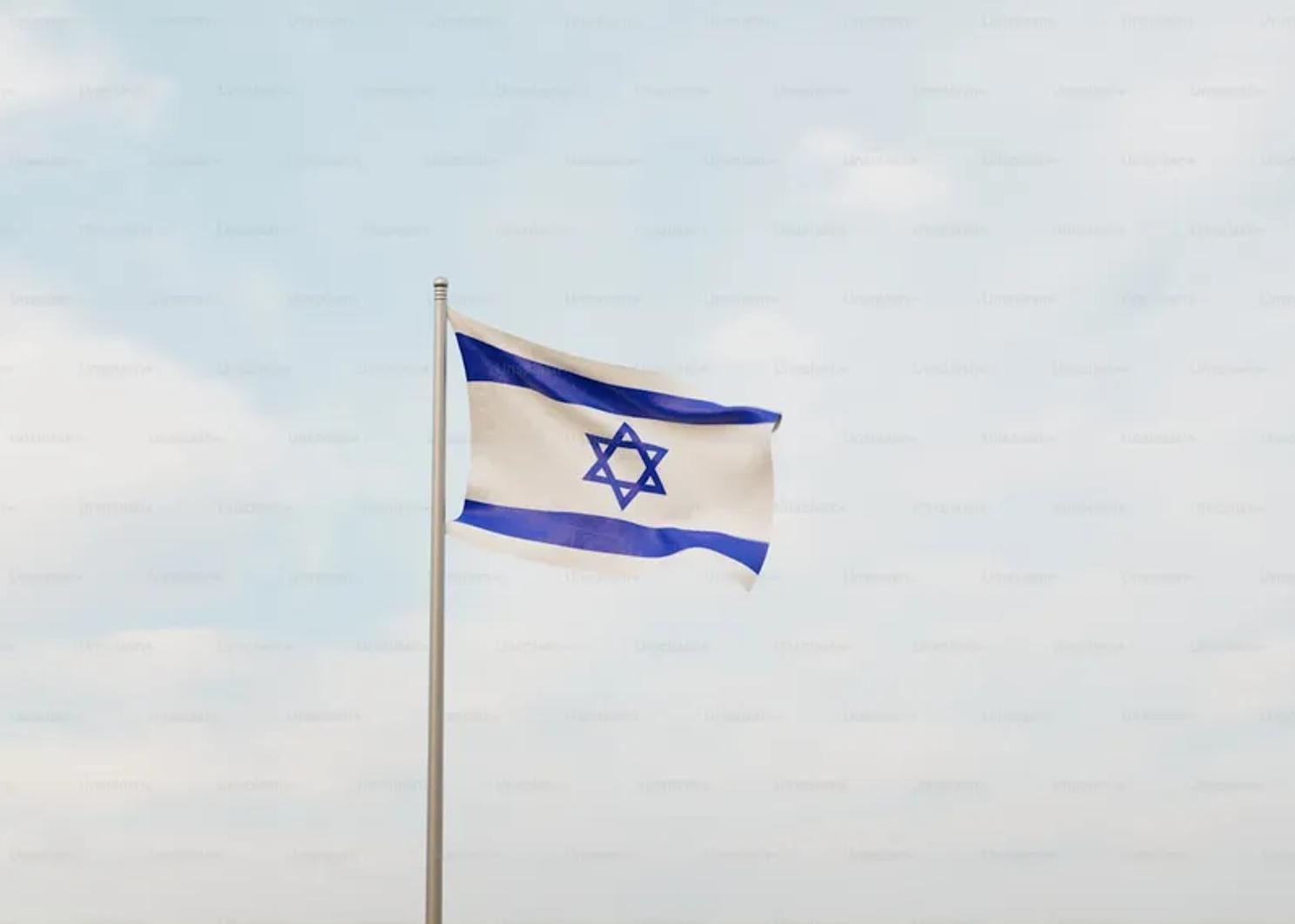 The flag of Israel waving against a blue sky