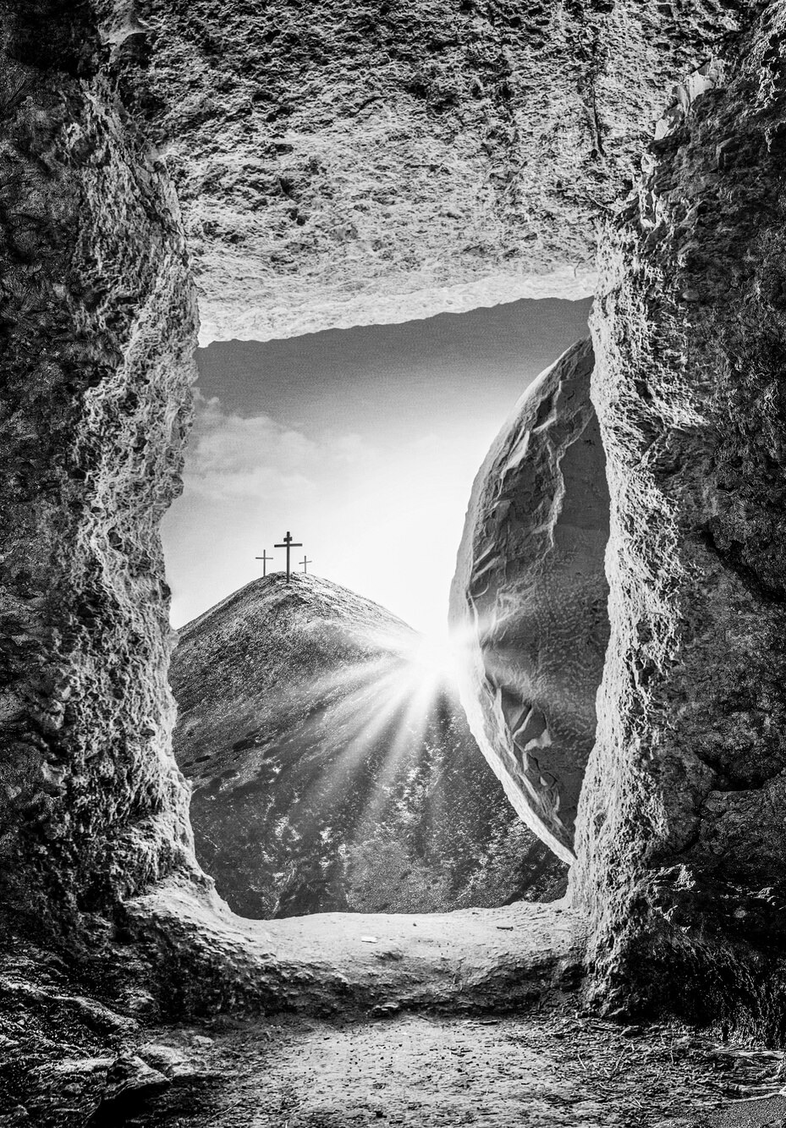 A cross-shaped opening glowing inside a dark cave