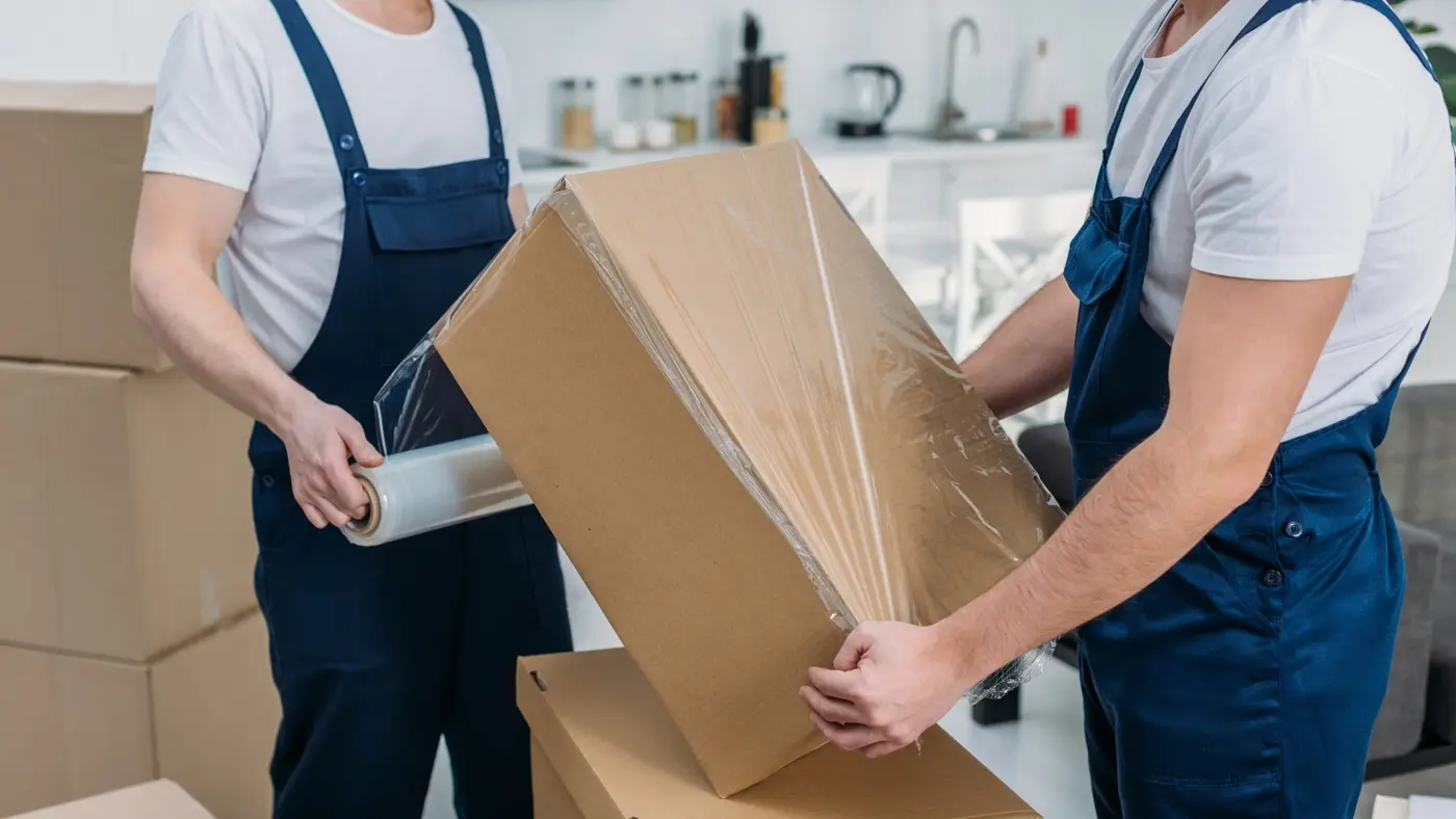 Professional Movers Carefully Wrapping Items for Safe Transportation