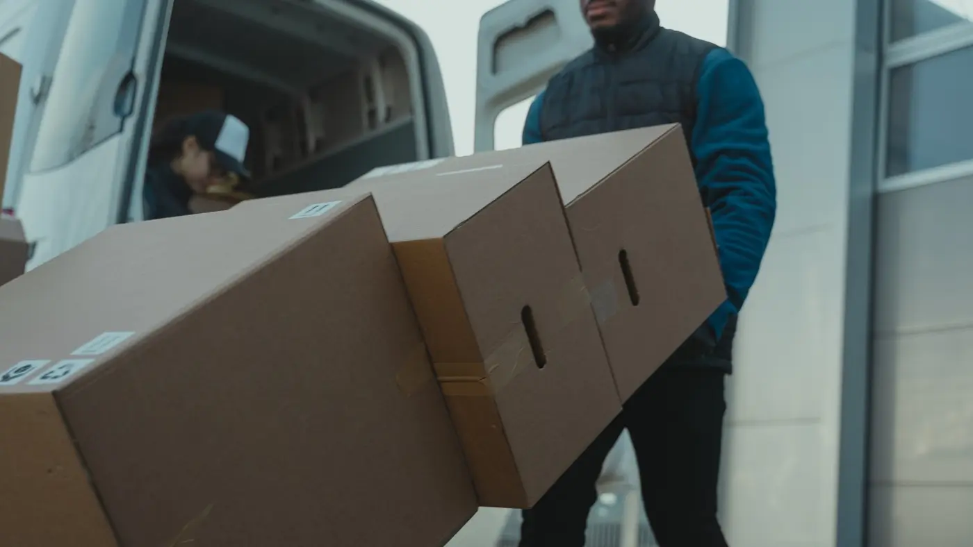 A person moving furniture using a moving cart.