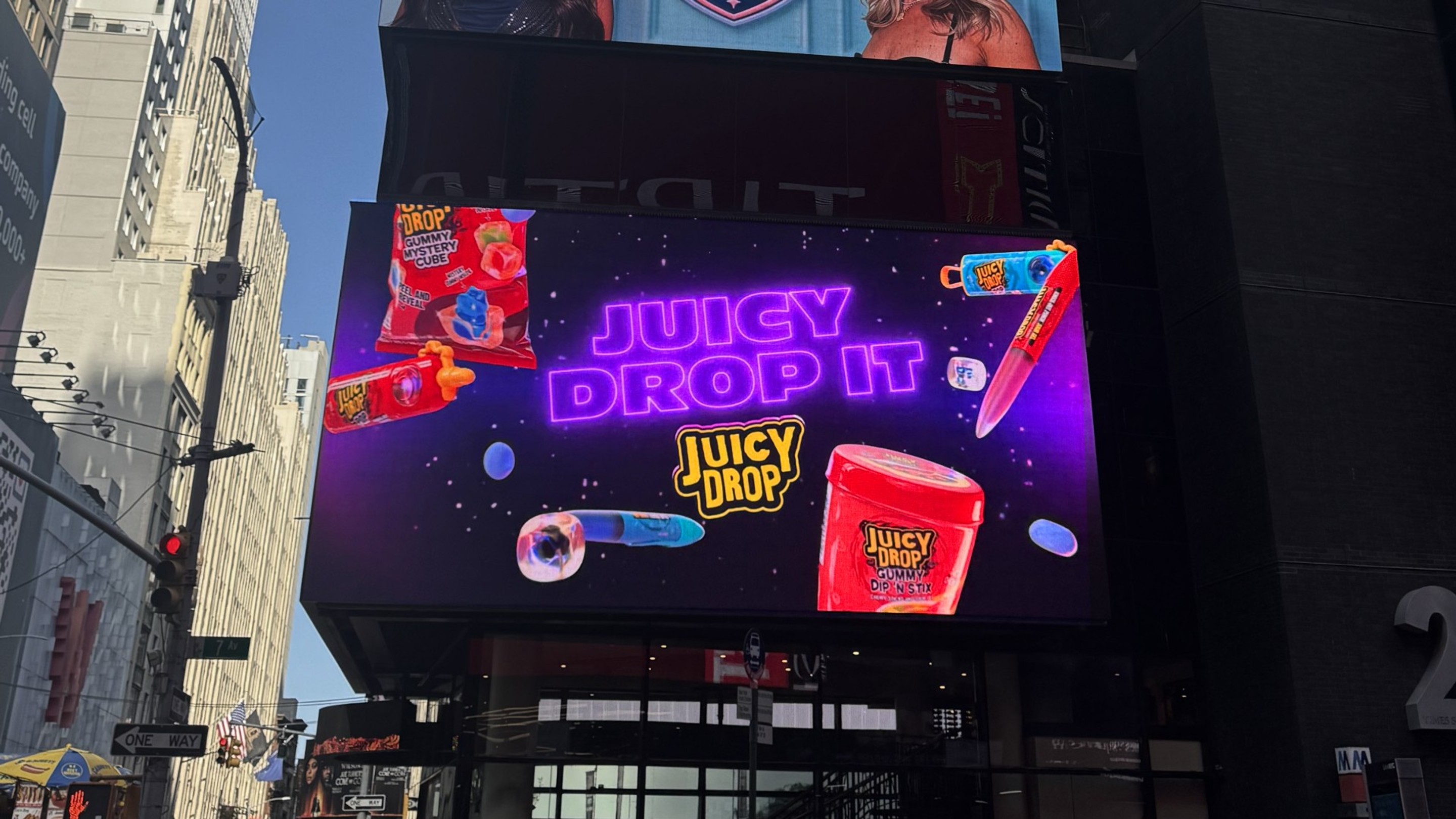 Times Square Billboard with a Juicy Drop image displayed.