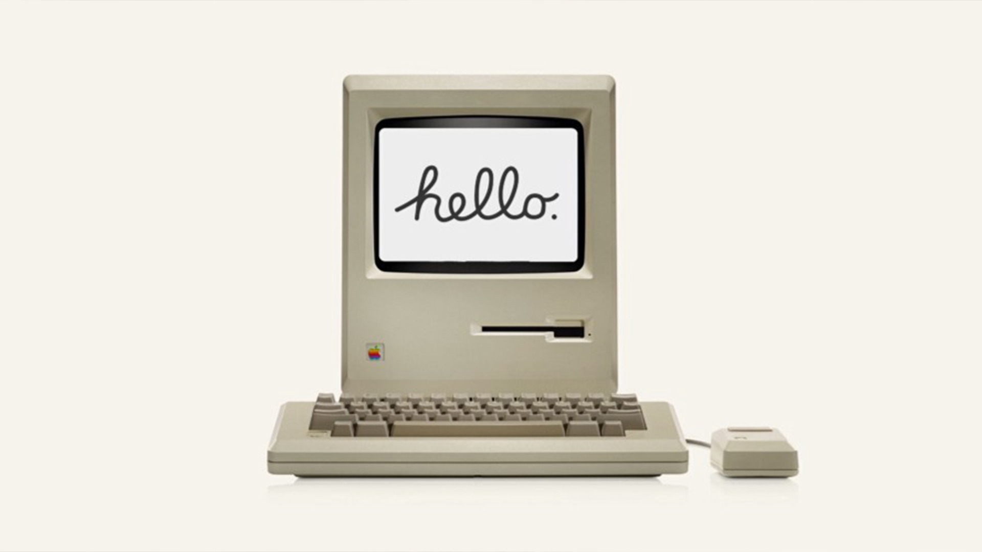 an old mac computer with a keyboard and mouse on a white background .