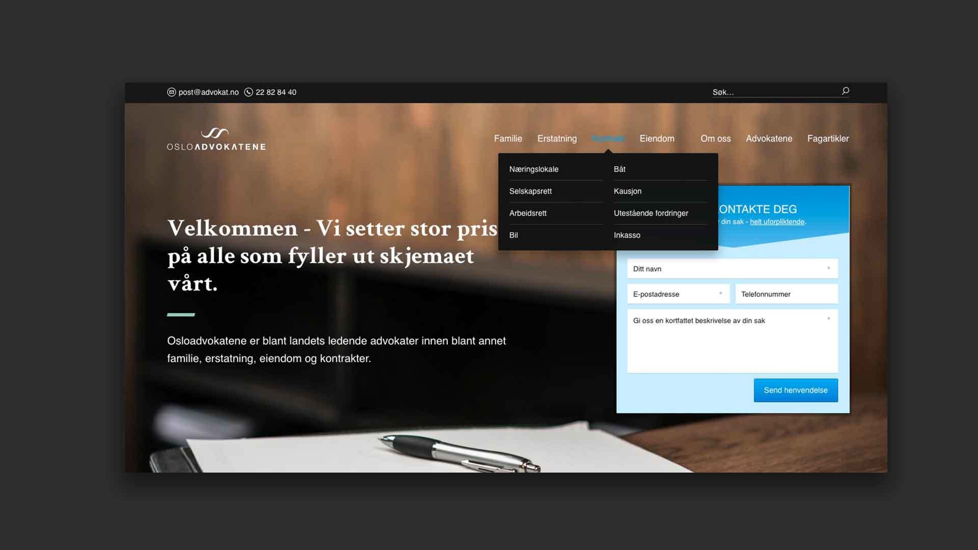 et skjermbilde av en nettside med en penn og et stykke papir på et bord