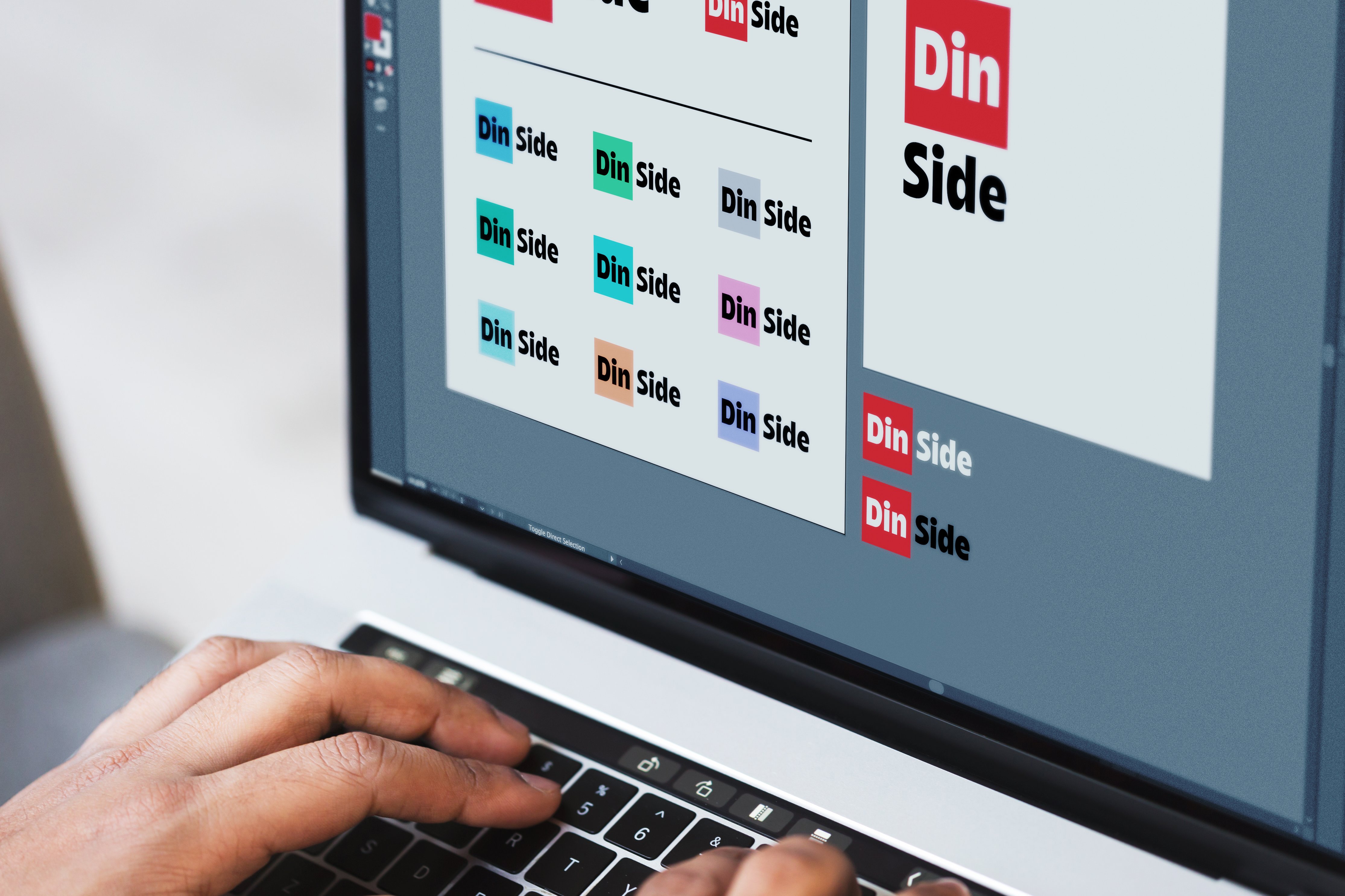 Logoen til din side i ulike farger. Viser designer som jobber på den. Foto.