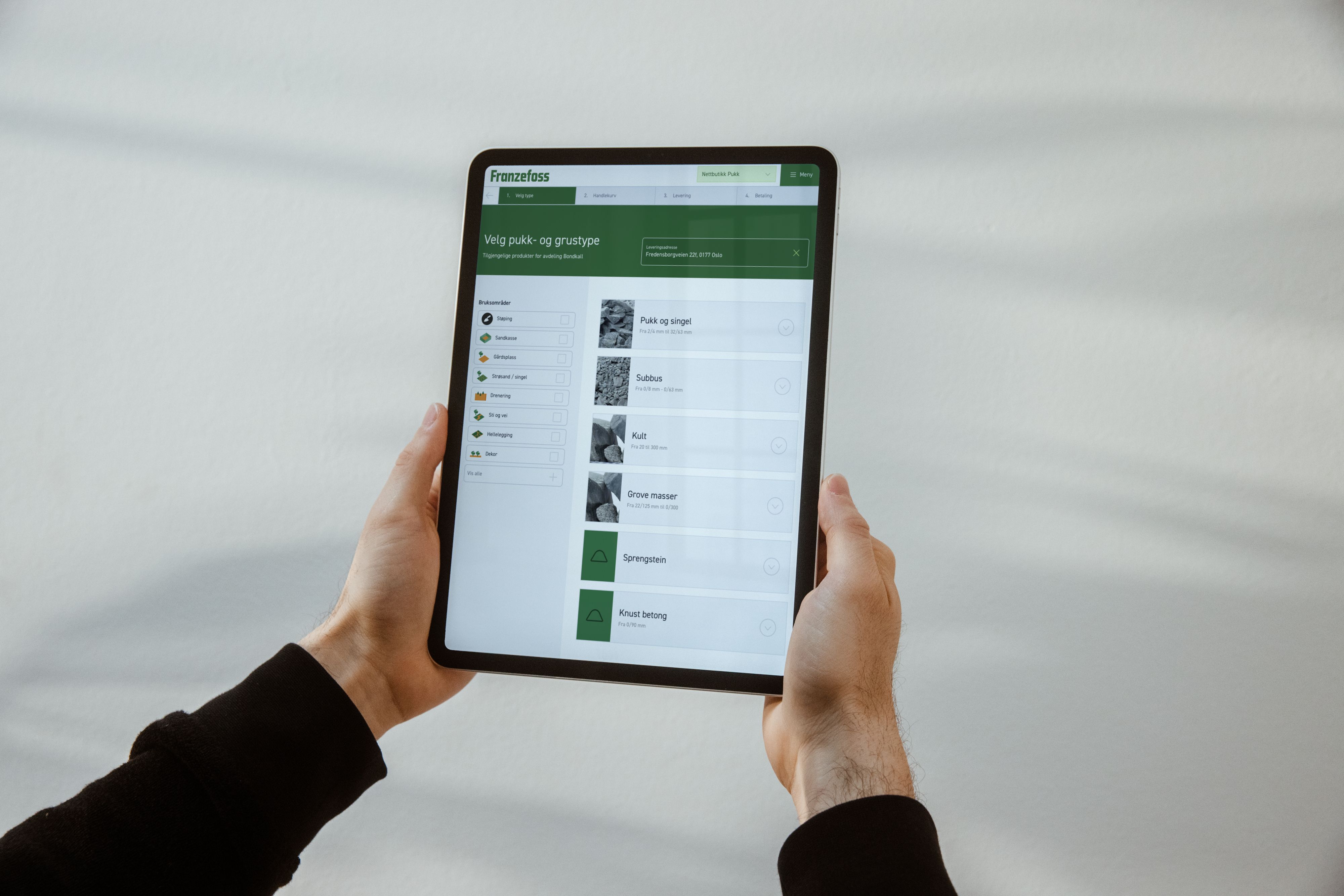 a person is holding a tablet in their hands .