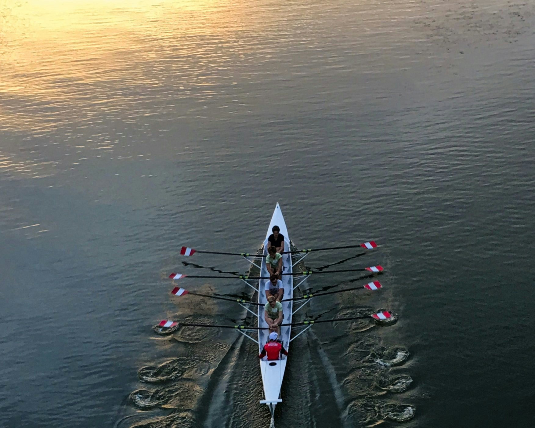 a group of people are rowing a boat in the water