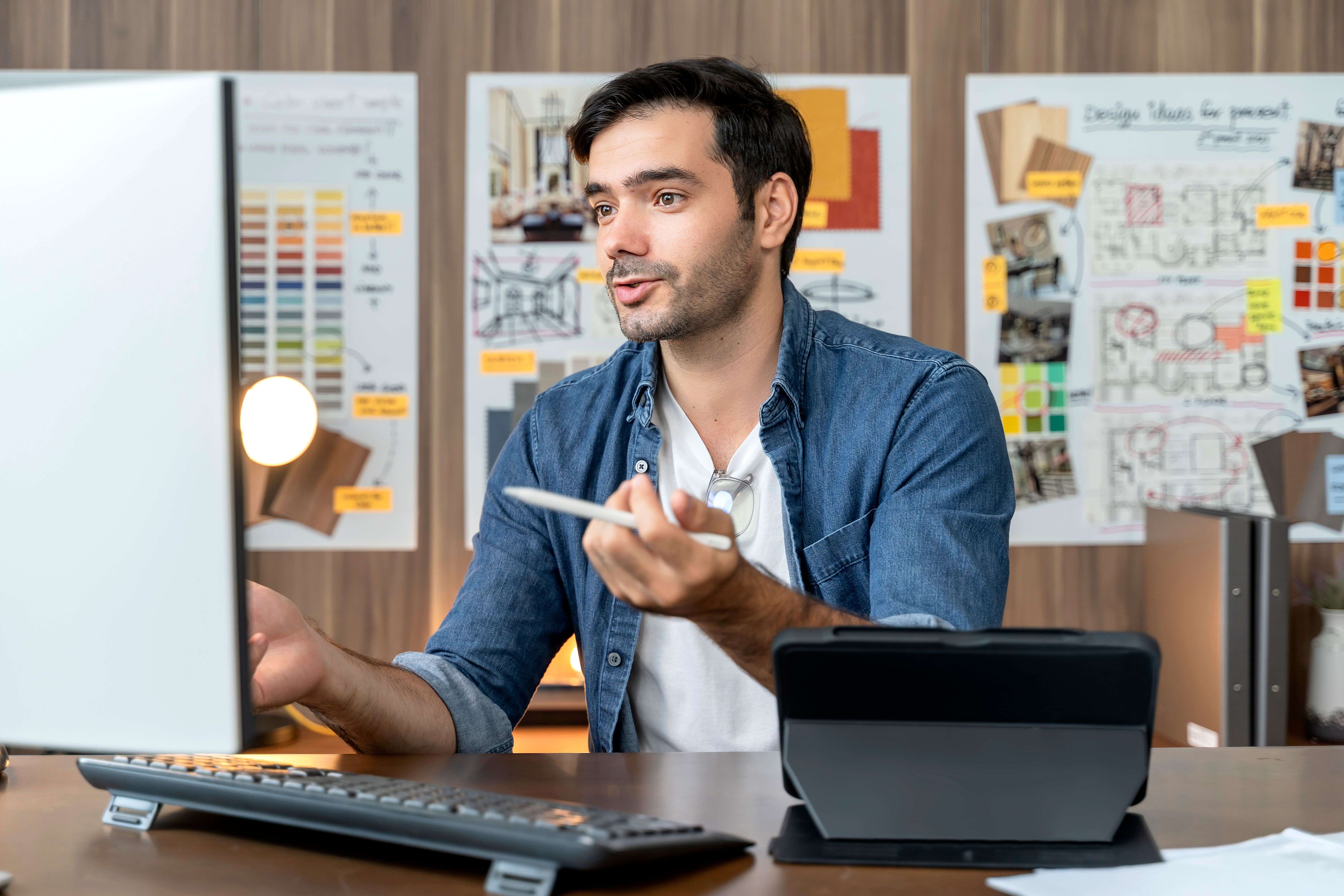 a man sitting at a desk in front of a computer