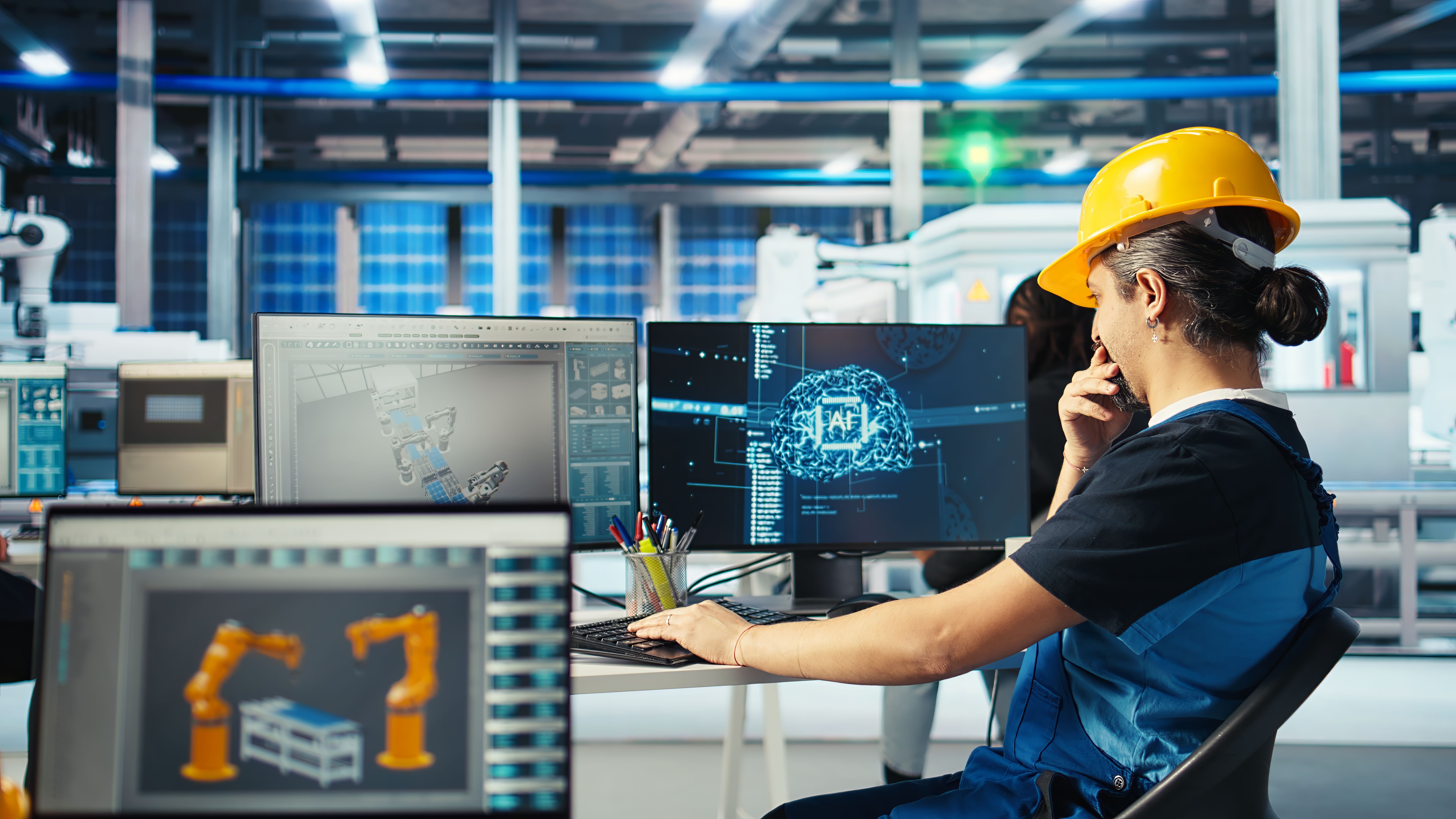 a woman in a hard hat working on a computer