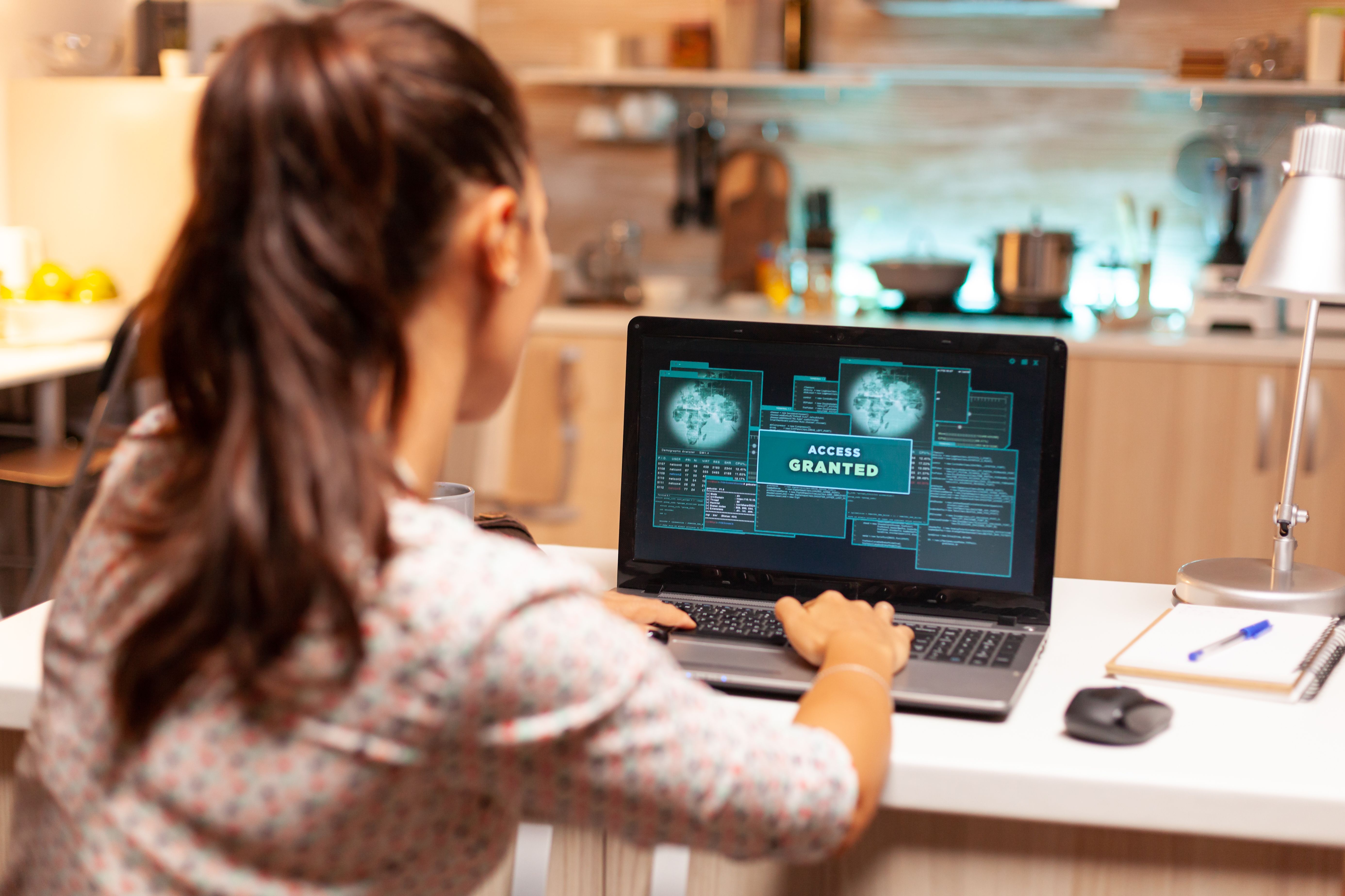 a woman sitting in front of a laptop computer