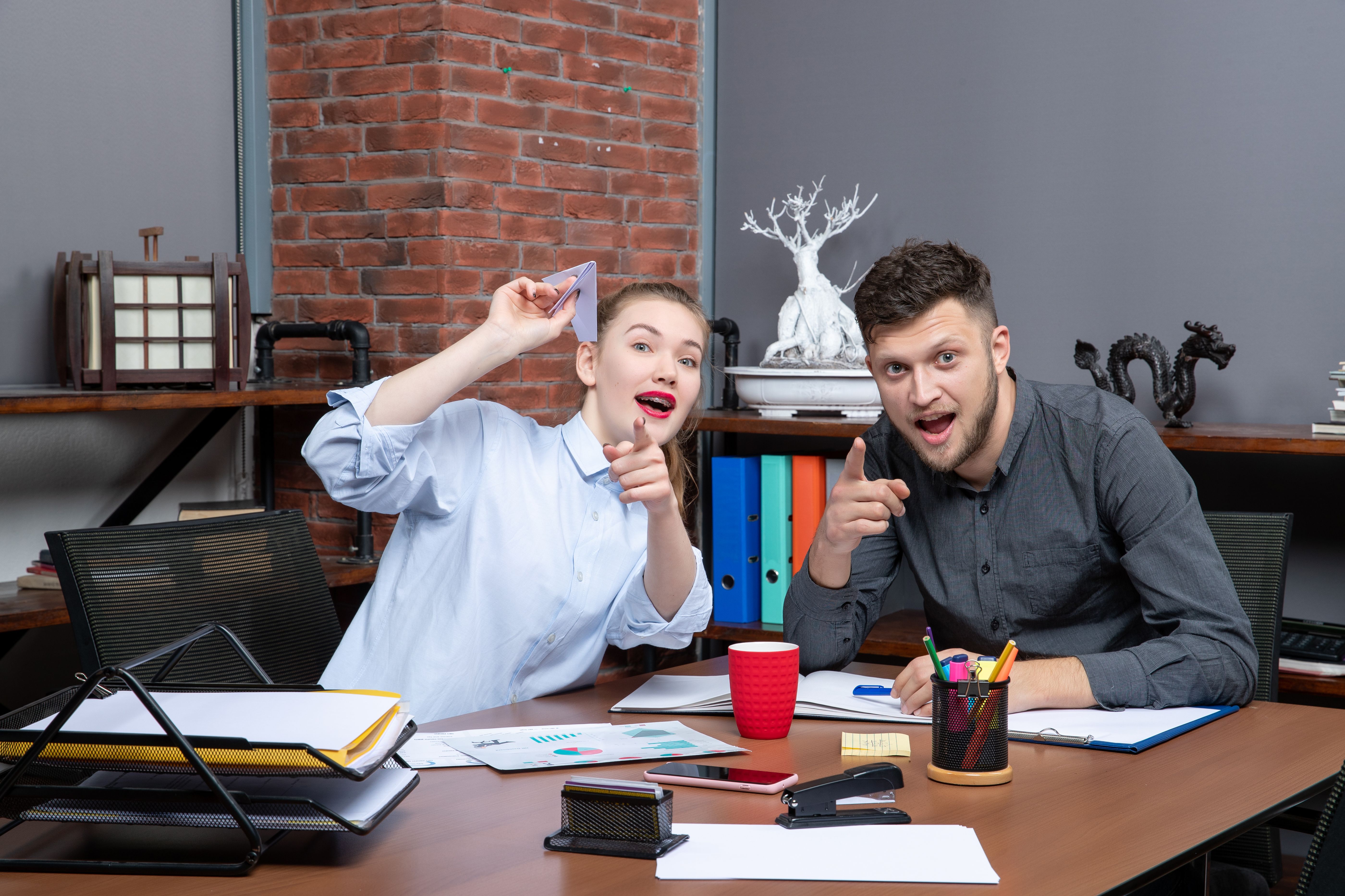 a man and a woman sitting at a desk
