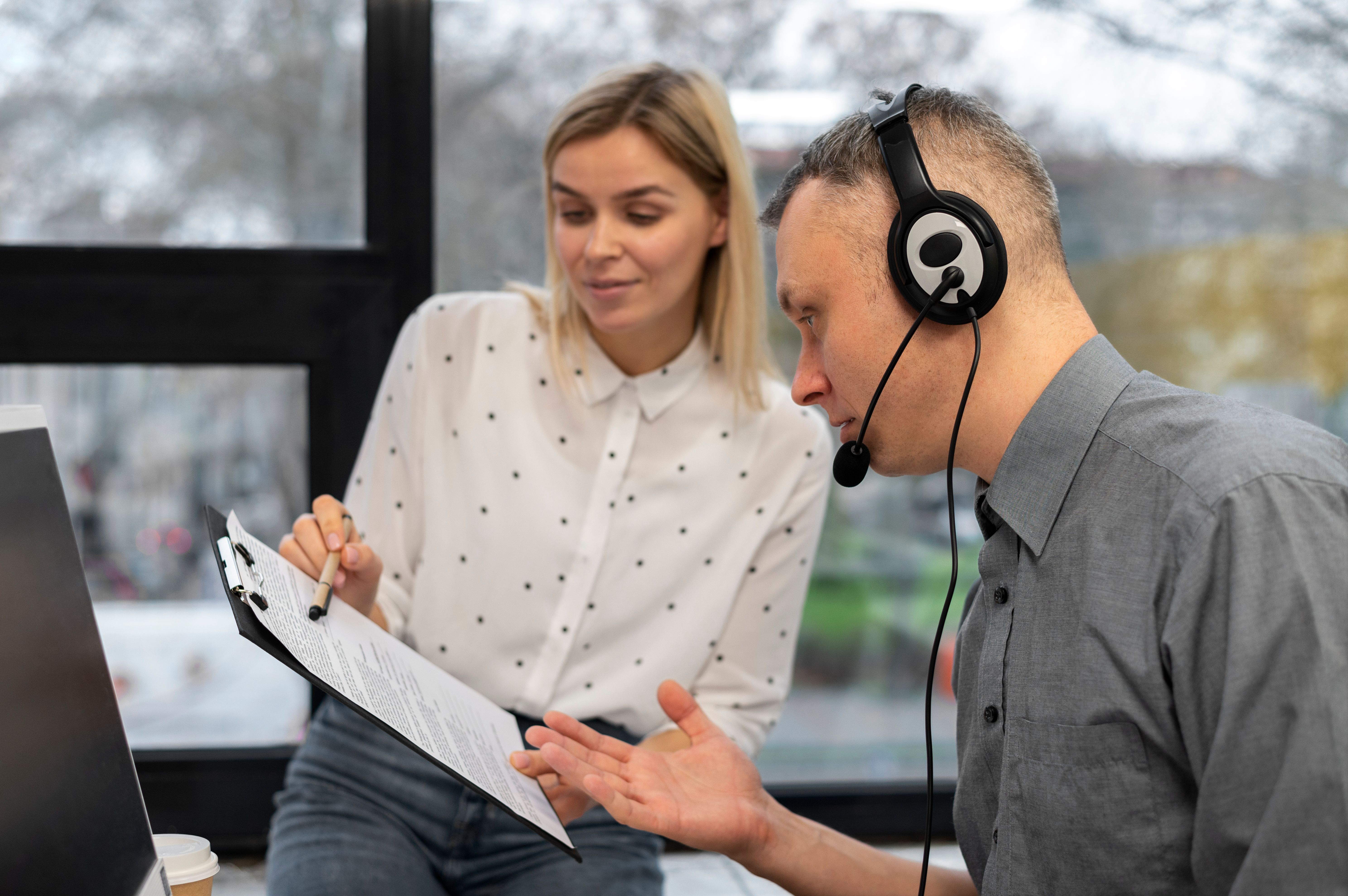 a man and a woman sitting in front of a computer