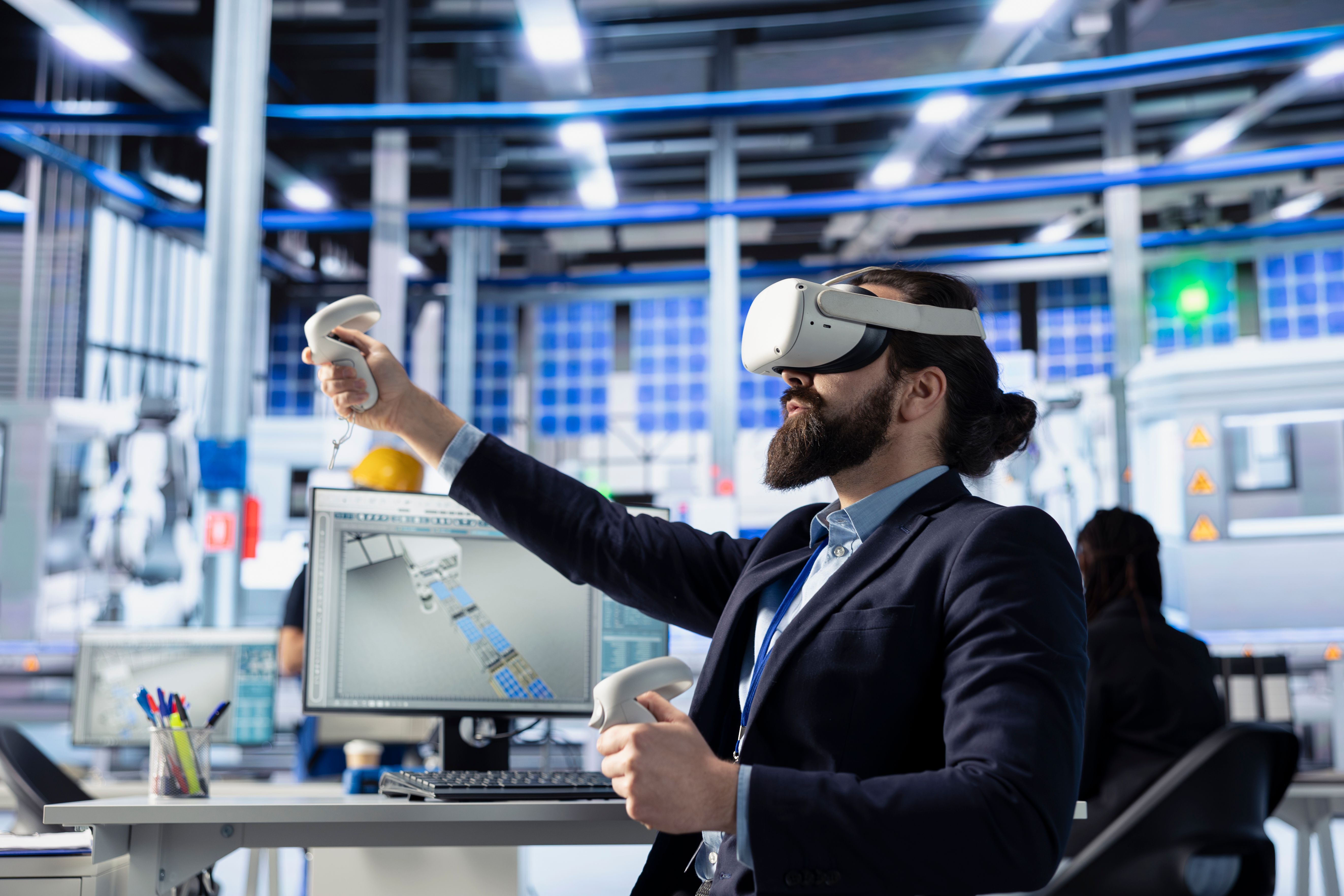 a man wearing a virtual reality headset in front of a computer