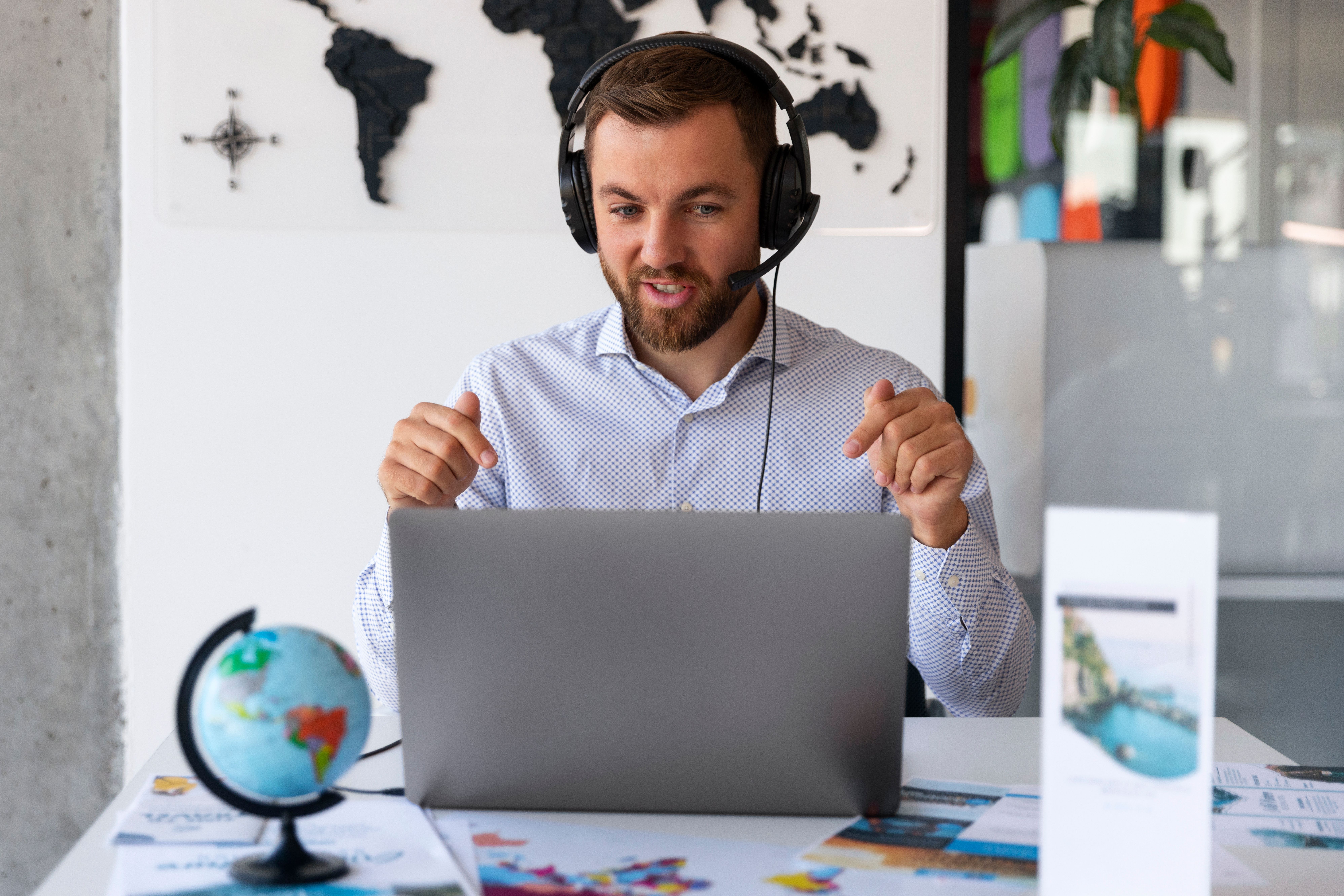 a man wearing headphones and using a laptop