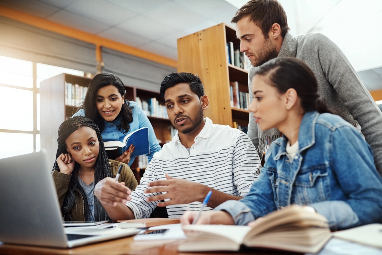 A group of people around a computer