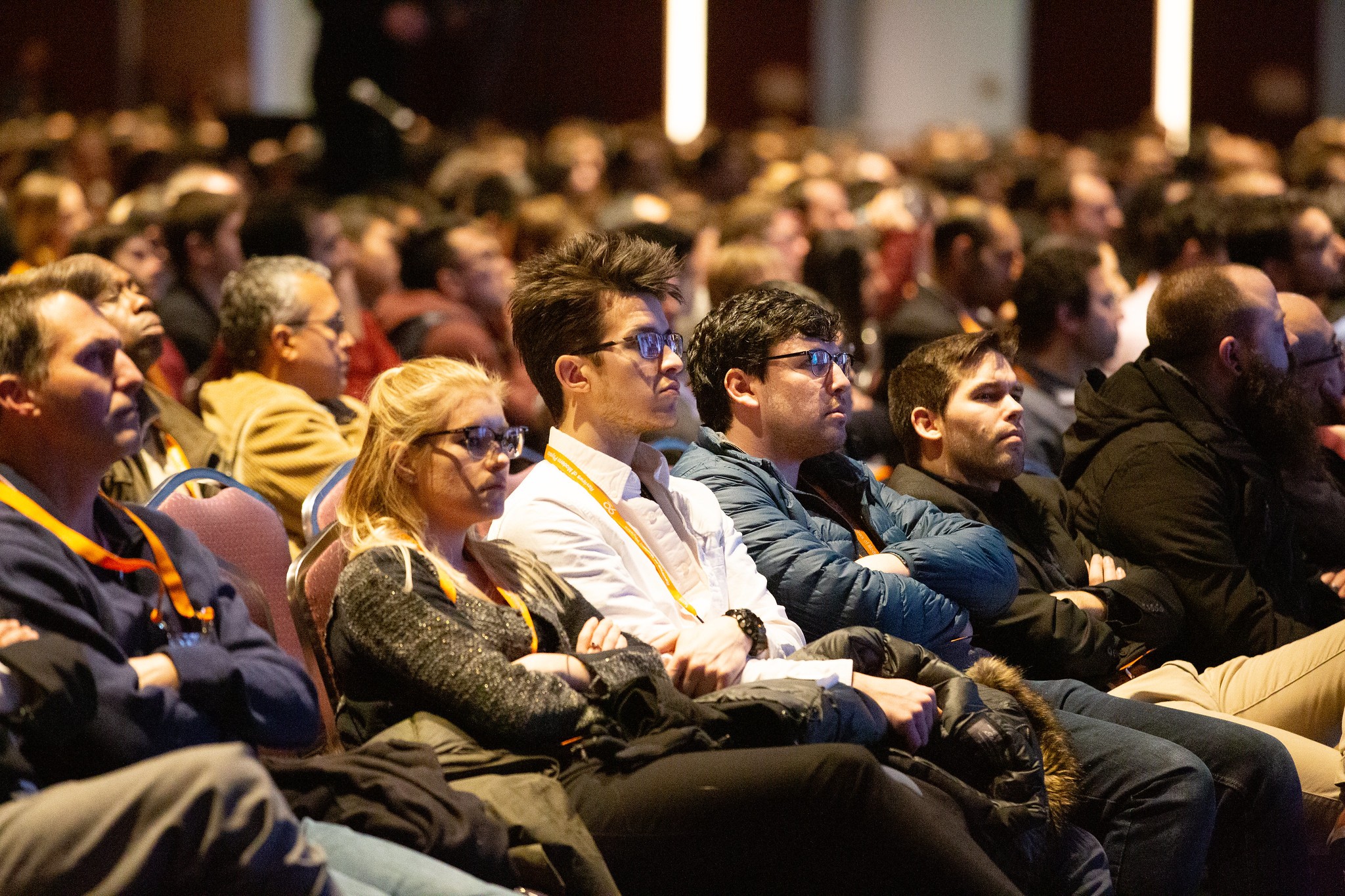 Audience watching a keynote presentation in a large hall