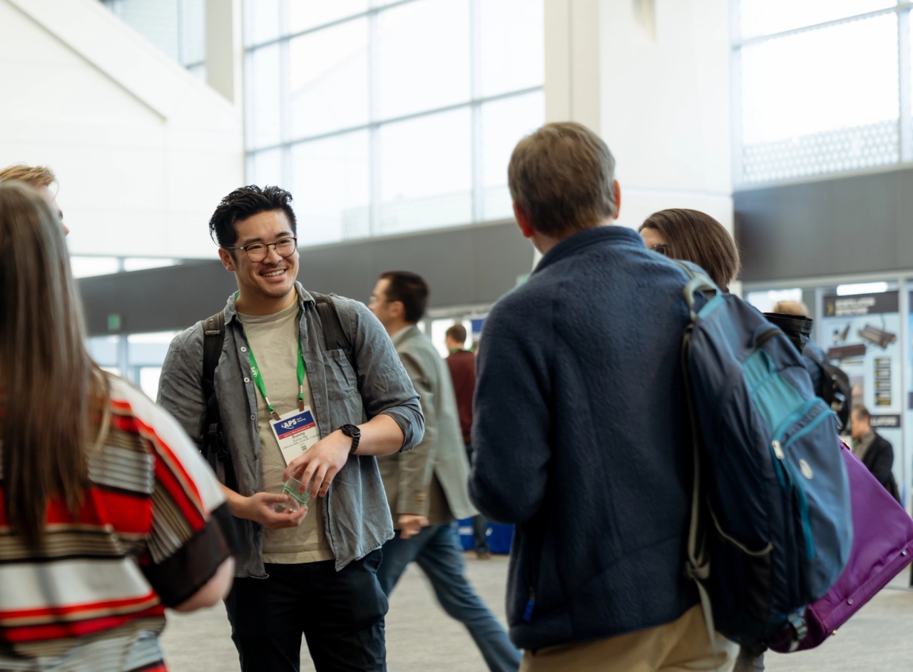 Attendees mingling outside of a session room. 