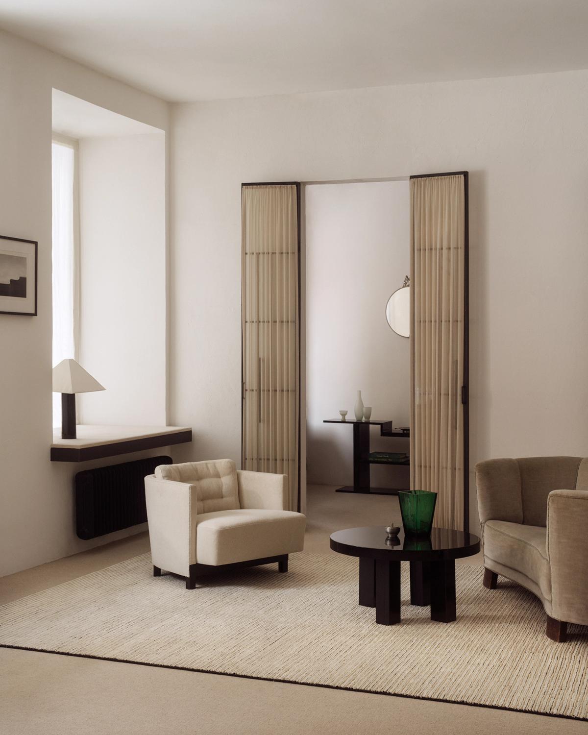 Twin 01 flatweave rug photographed in a stylish living room with neutral colored furniture in Stockholm, Sweden.