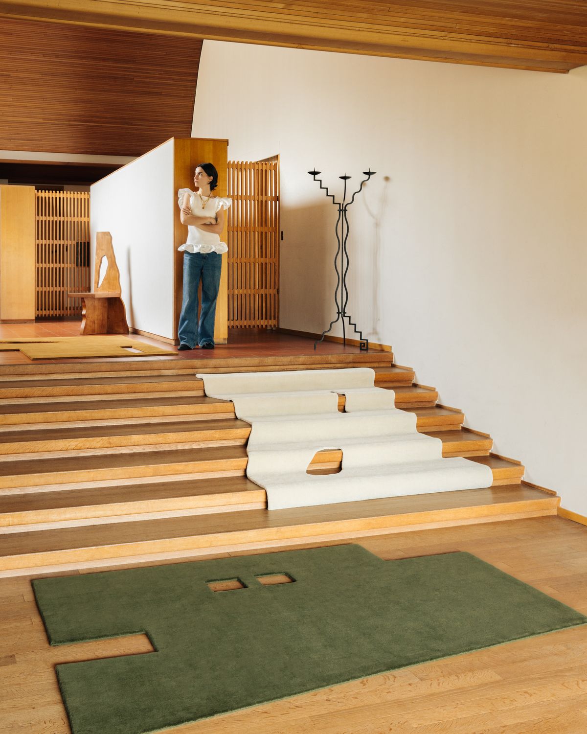 The geometrically shaped plush rugs Garance in Dusty White, Moss and Leo displayed in mid-century home together with the artist.