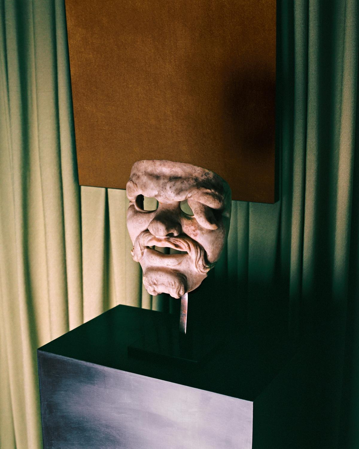 The Grand curtain in Pale Green and a painting of the Grand rug in Leo displayed behind a marble statue at Galerie Chenel in Paris.