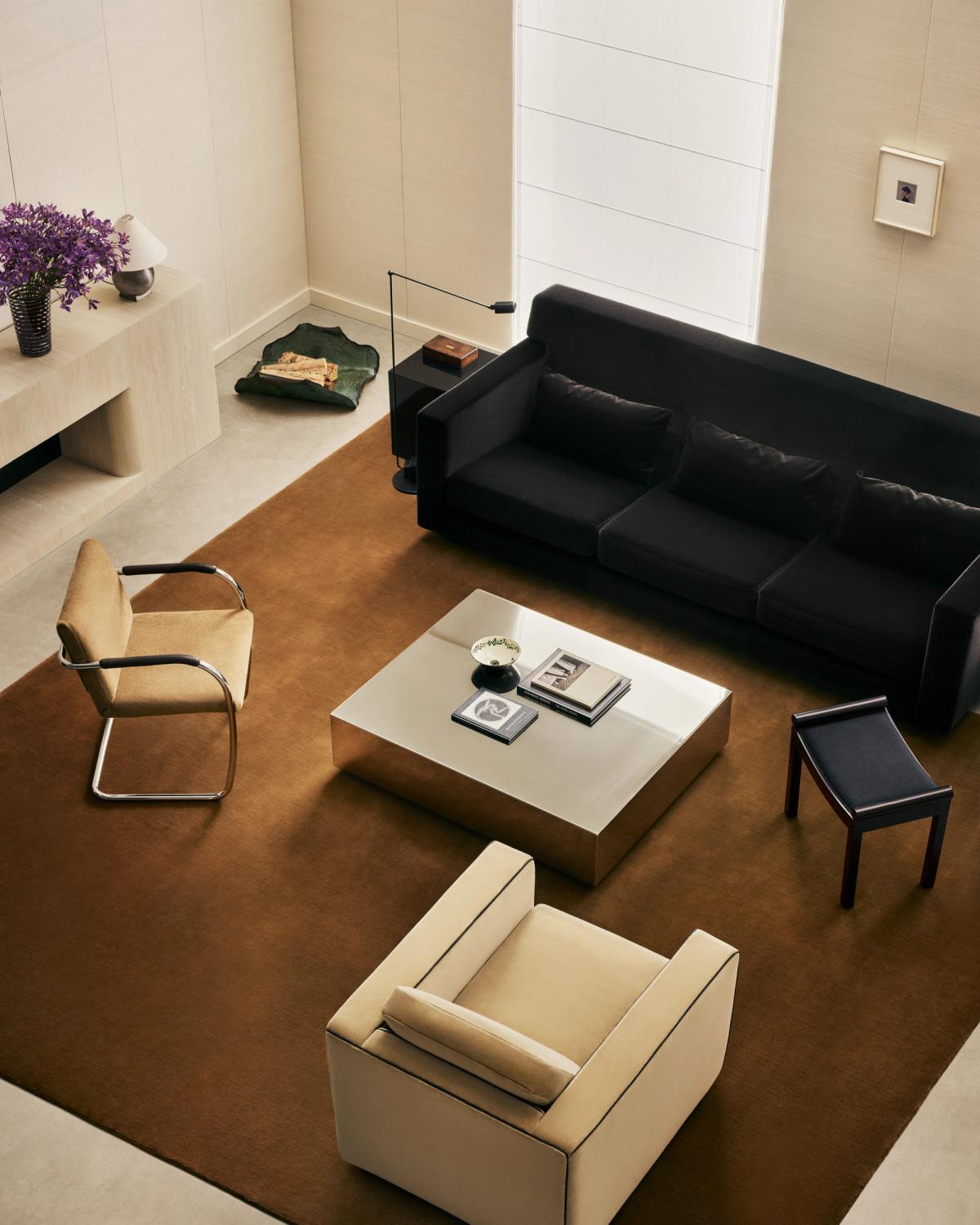Grand in Pecan, photographed from above in a bright living room beneath a black sofa and low coffee table.