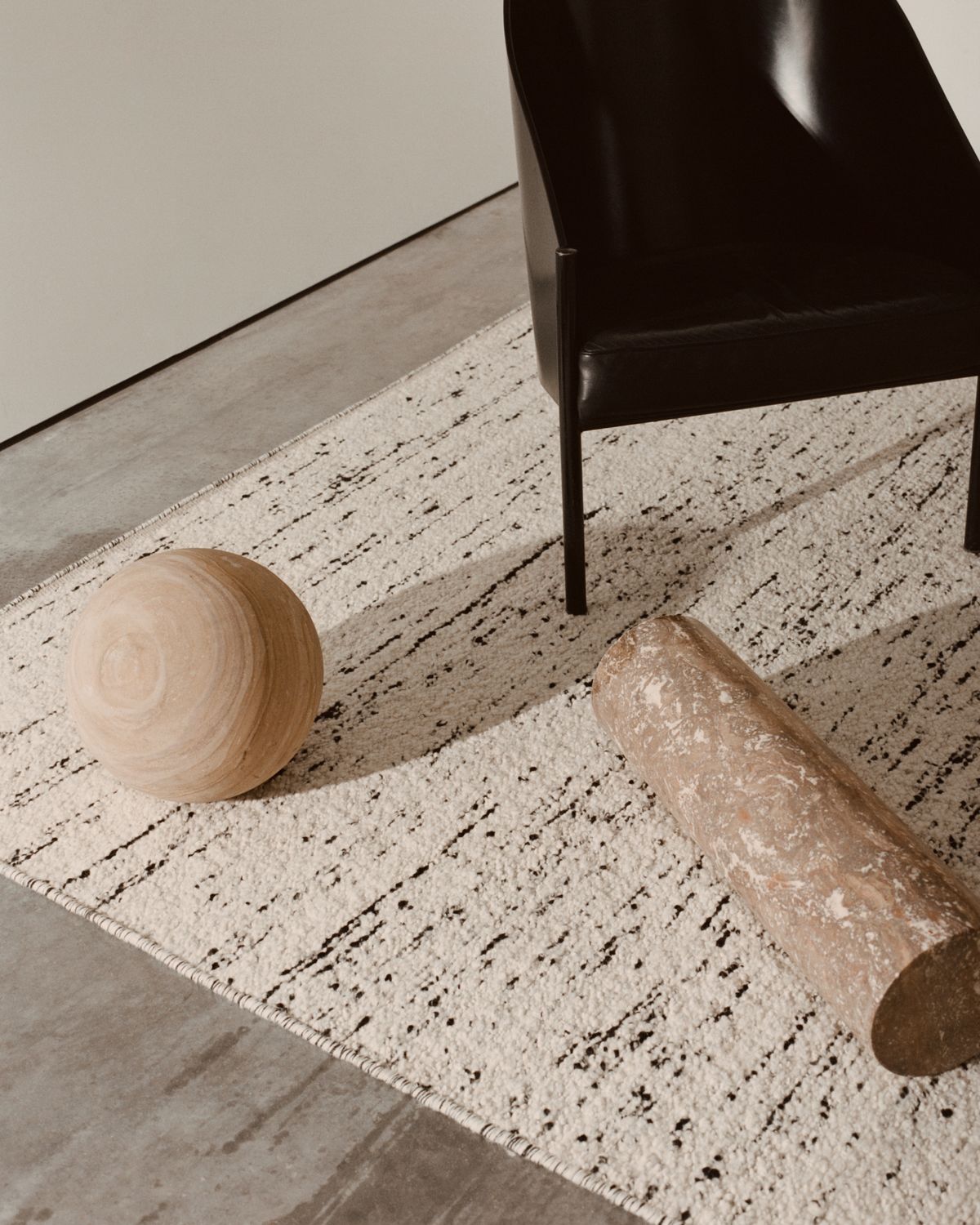 Bouclé Black and White in close up with objects on the floor.