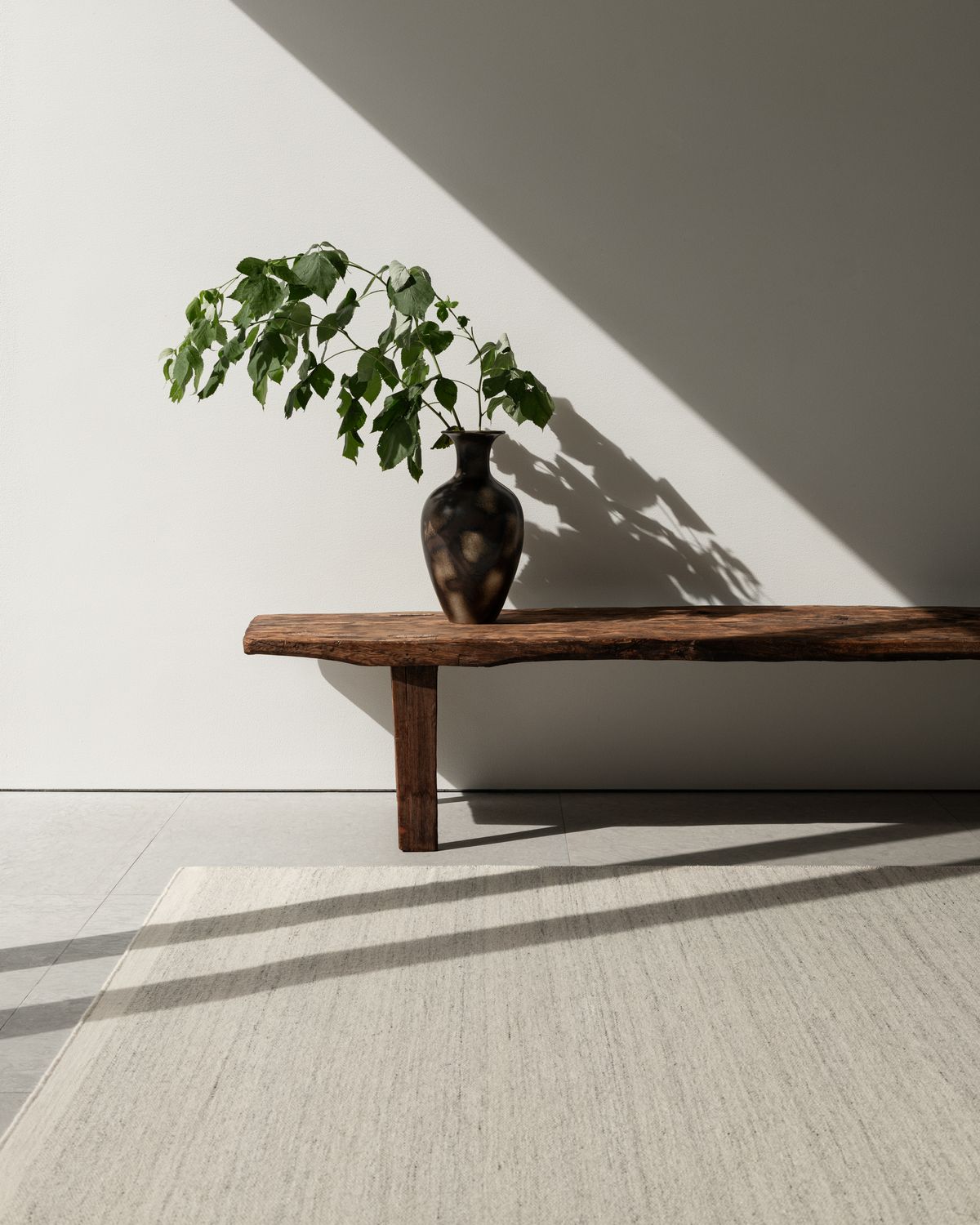 Zero in Cream Mix shown in a sunny setting with a wooden bench styled with a vintage vase.