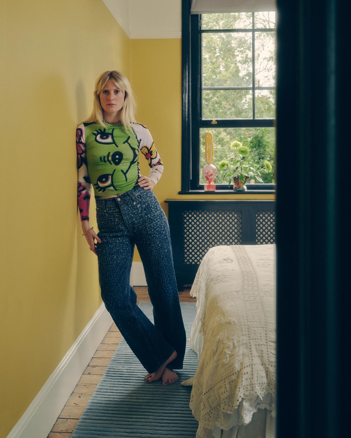 Christabel MacGreevy photographed in a yellow bedroom featuring the plush wool rug Park 02 in Sky.