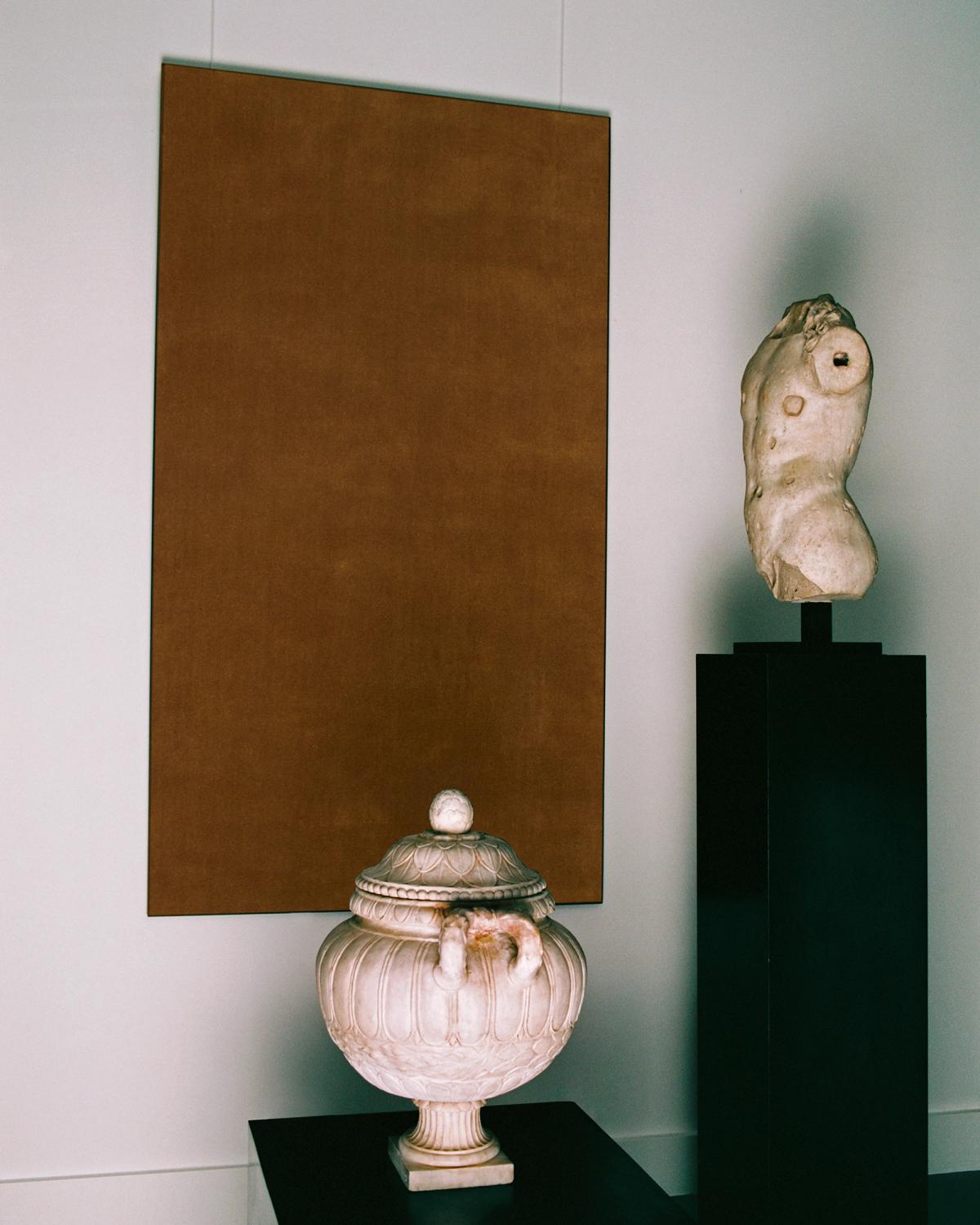 A painting of the Grand rug in Leo hanging on the wall behind sculptures at Galerie Chenel in Paris.