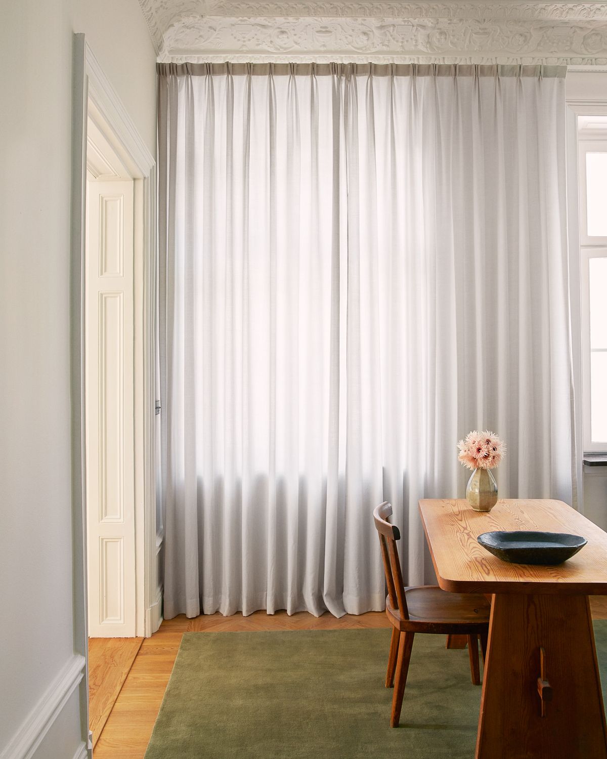 Wool Curtain The Grand in the color Soft Gray displayed in an office with wooden interior details and the plush wool rug Grand in Moss.