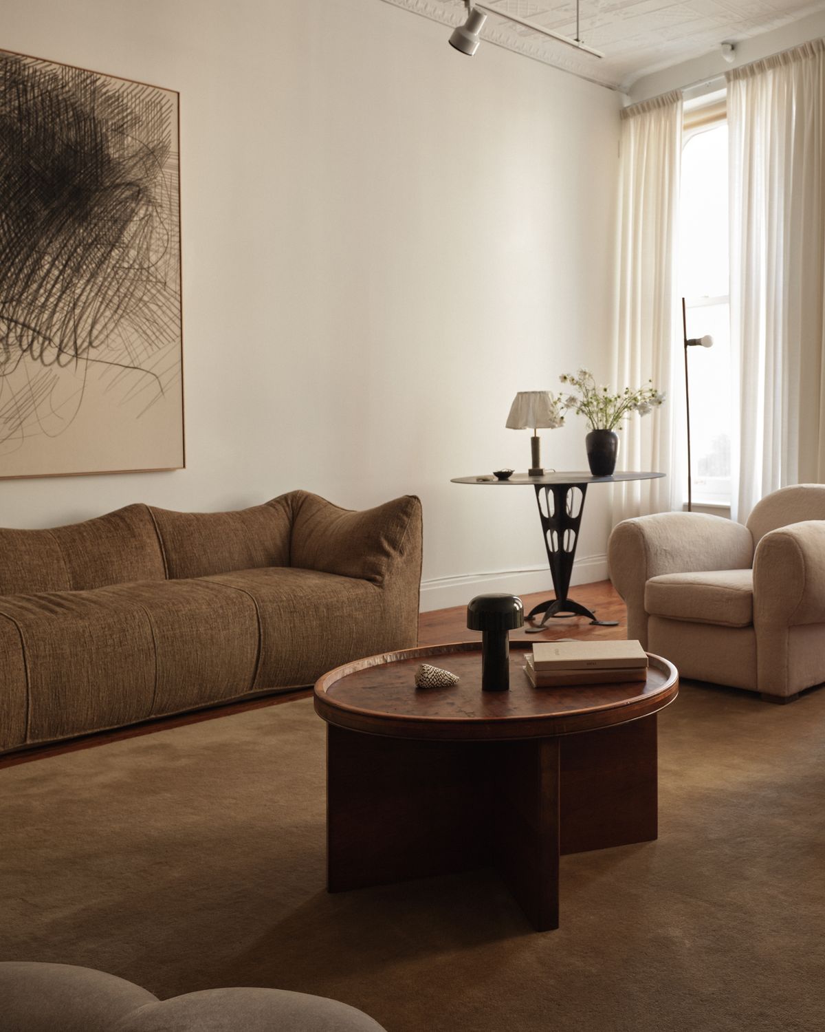 Plush wool rug Grand Chestnut pictured in a stunning New York living room with neutral coloured furniture and a large painting.