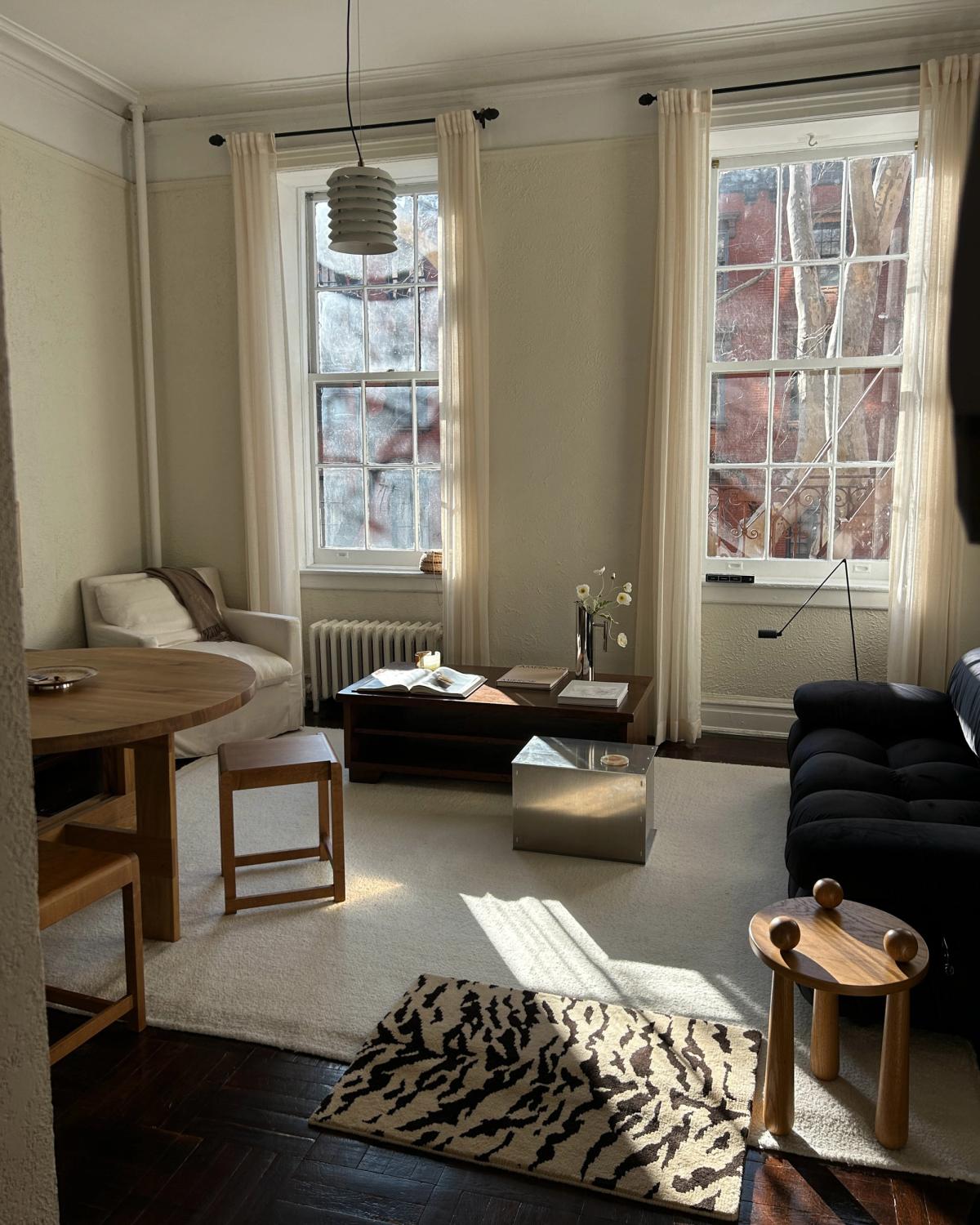 Photograph of Jessie Andrew's living room with neutral coloured furniture and a large sample of the plush wool rug Tigris x Nordic Knots.