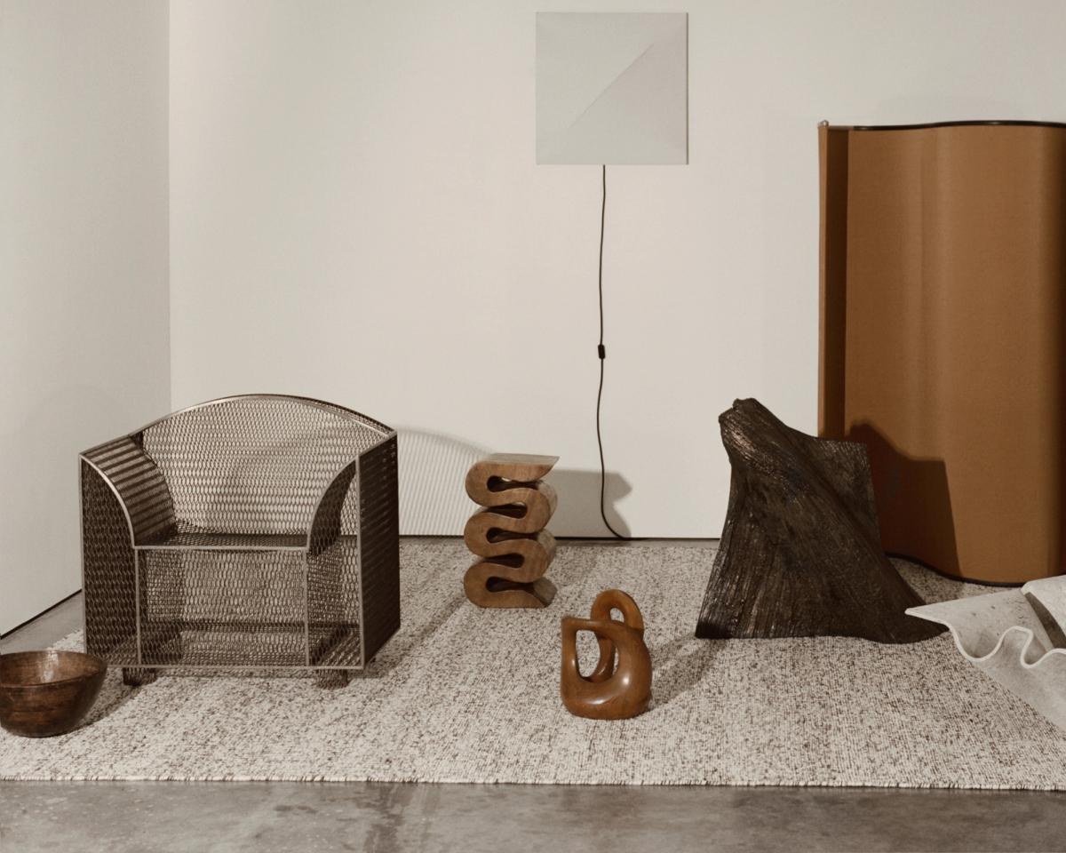 Bouclé – Dark Brown brings soft texture and tonal depth to this sculptural setting. Its richly woven surface grounds the interplay of bronze forms, natural materials, and minimalist lines with quiet tactility.