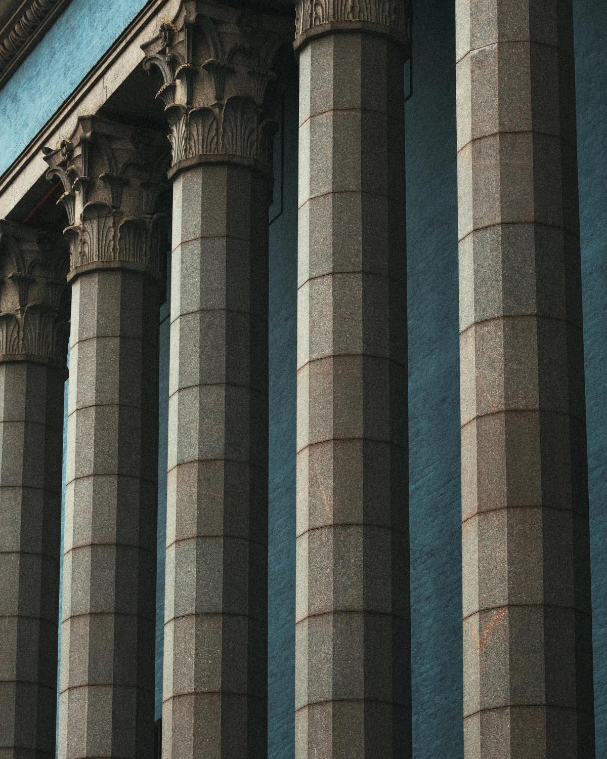 Tall neoclassical stone columns with ornate capitals at Stockholm Concert Hall, photographed in soft natural light.