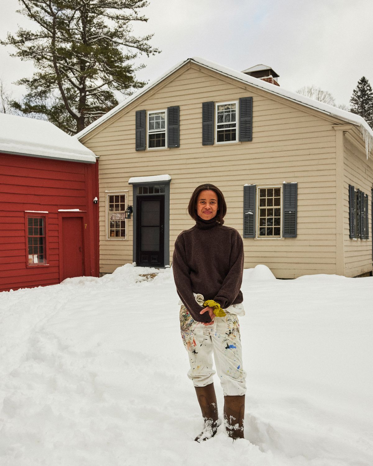 Cassi Namoda a contemporary Mozambican artist in front of her home in Massachusetts, US