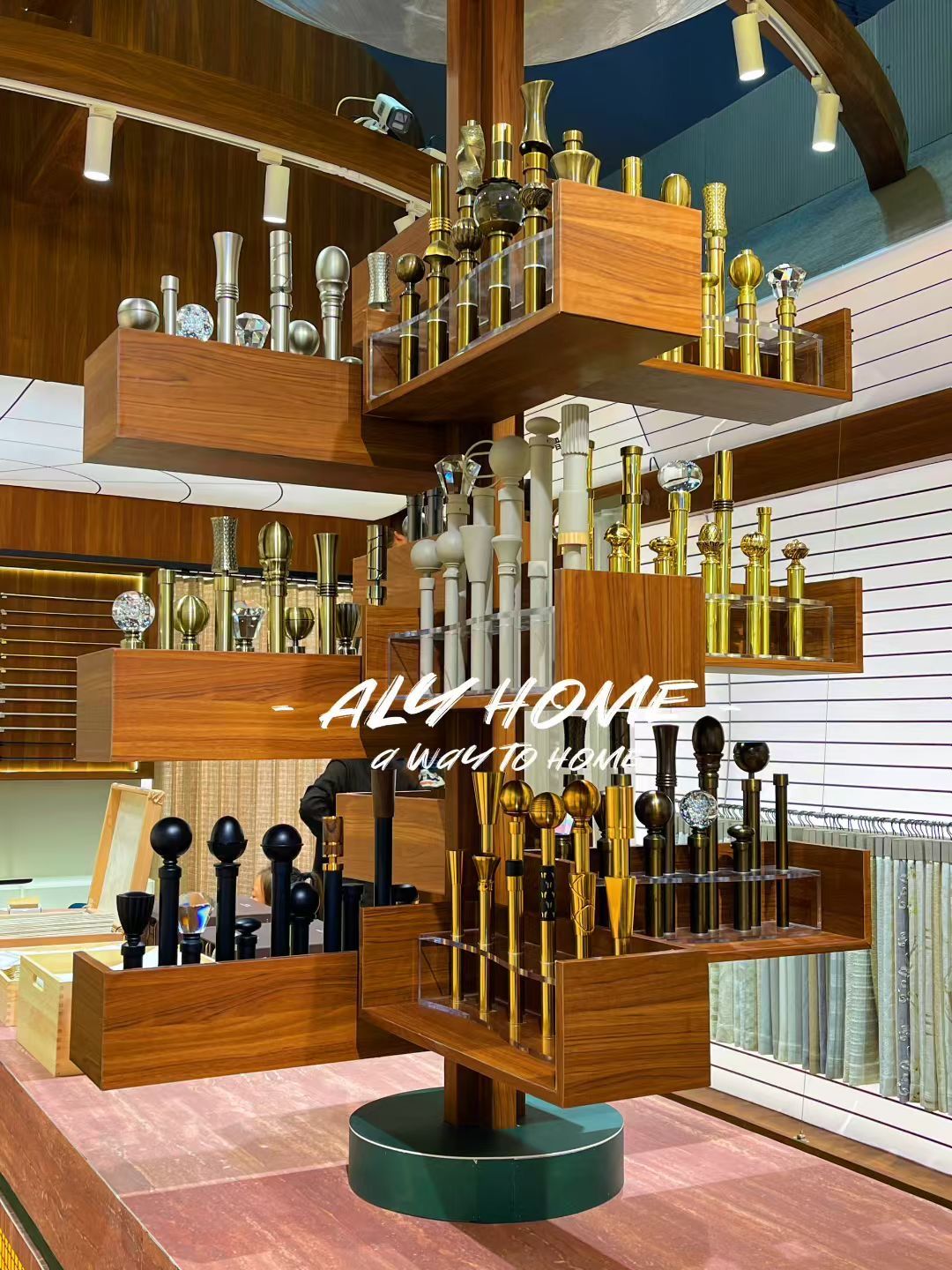 360-degree display tree of decorative curtain finials and tiebacks in gold, brass, and ceramic finishes