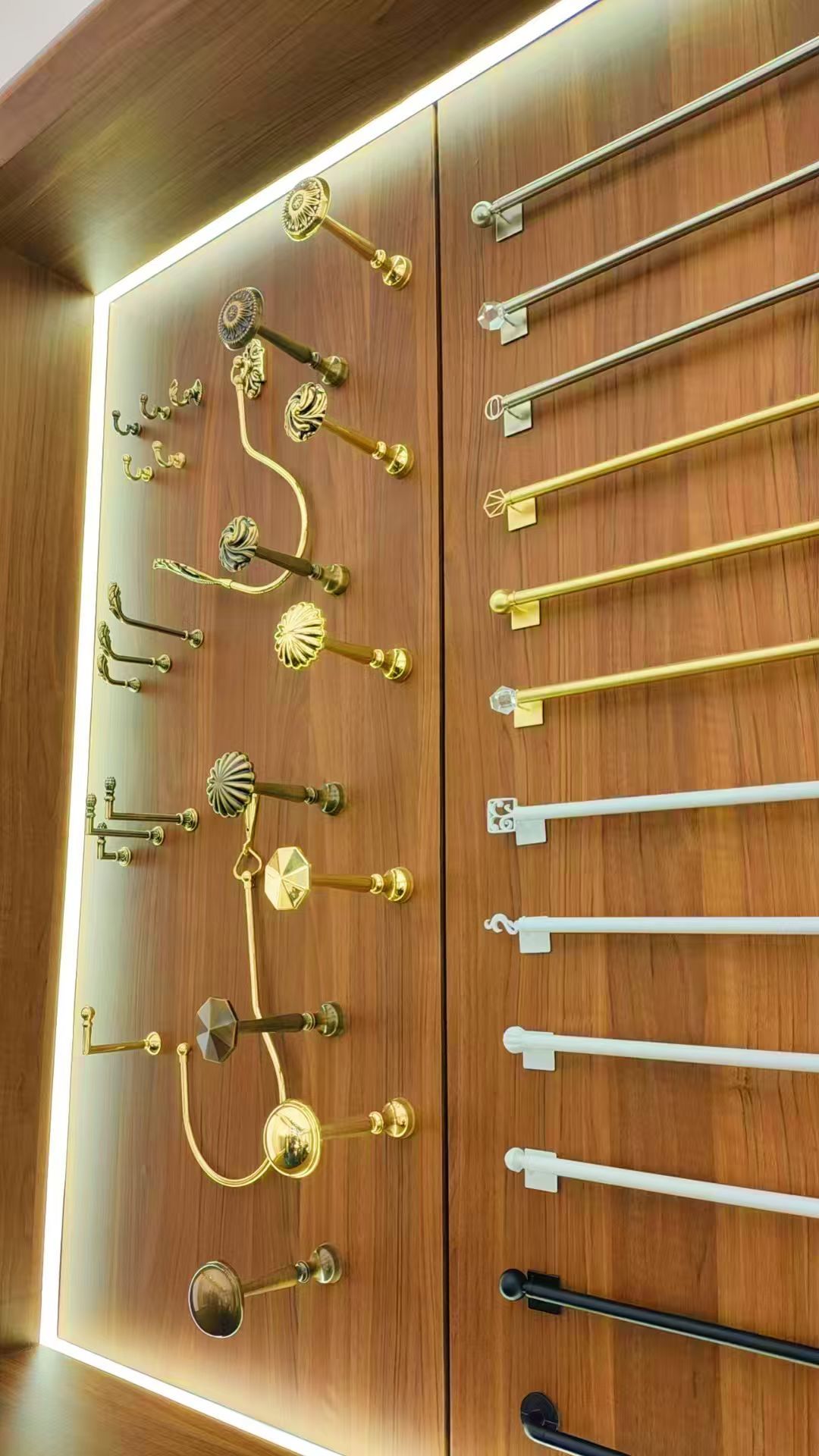 Wall display of curtain rod finials in gold, white, crystal, and black finishes at ALY HOME booth
