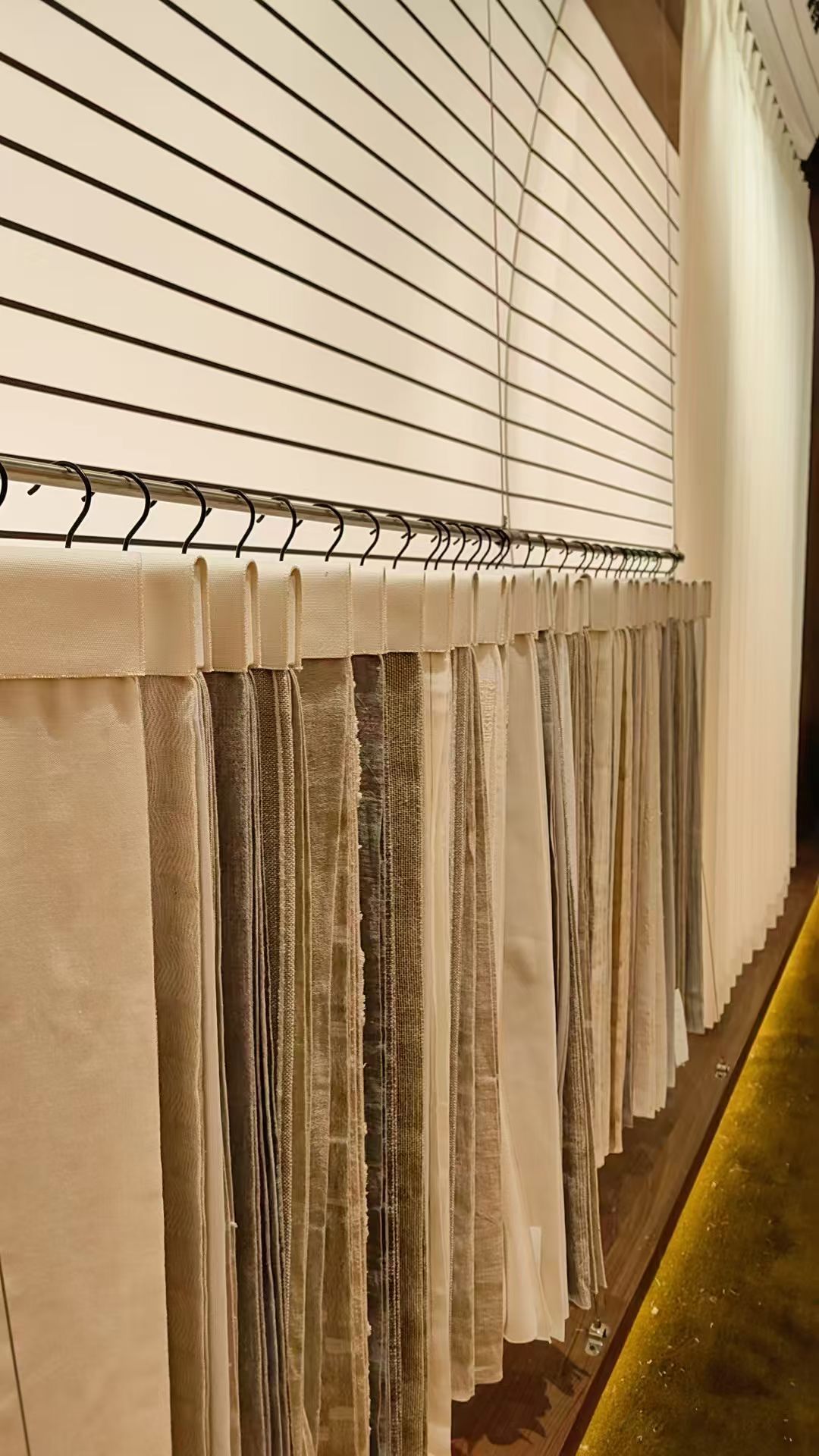 Curtain fabric swatch rail with multiple colourways displayed at ALY HOME booth