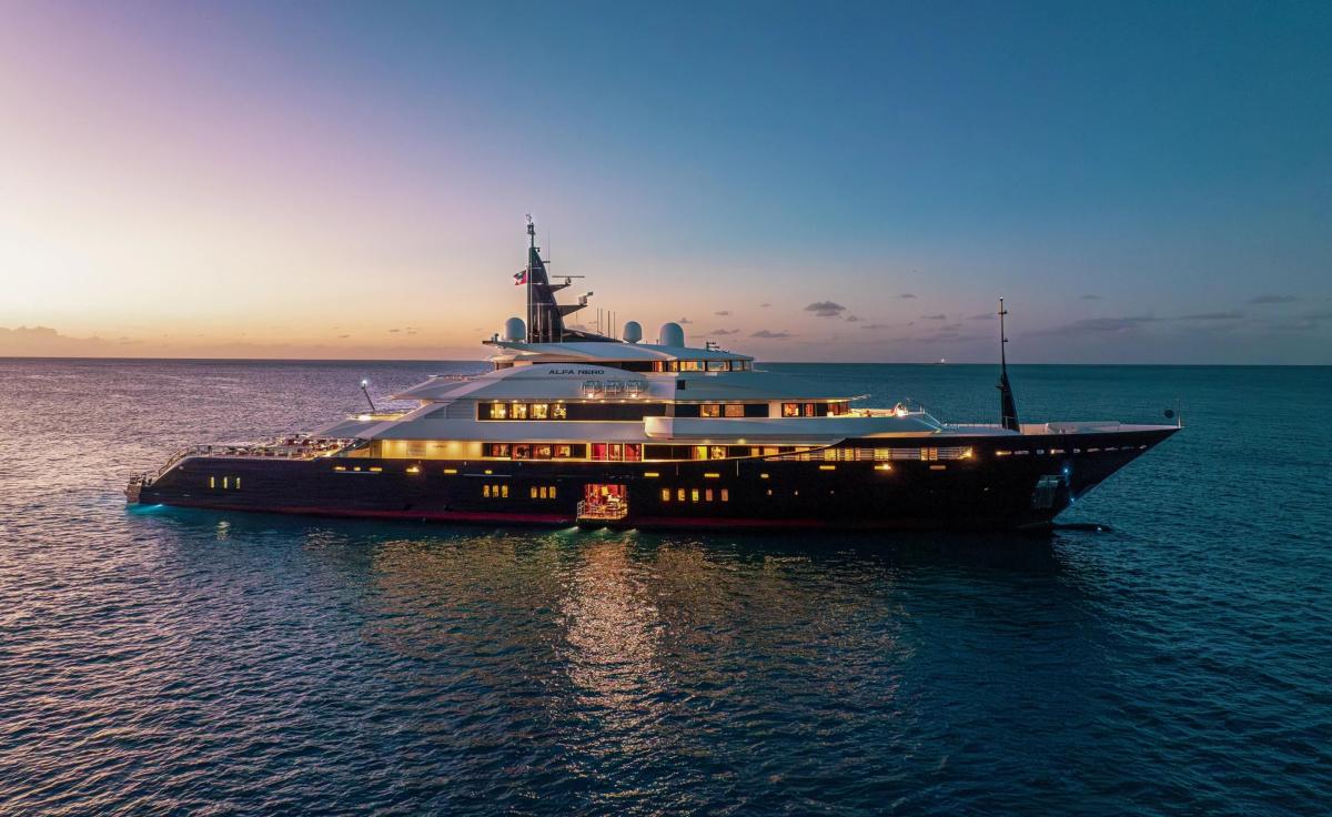 ALFA NERO at dusk with her deck lights on, 82m Oceanco motor yacht for sale