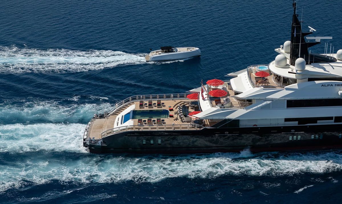 ALFA NERO aerial stern view under way with a tender in her wake, 82m Oceanco motor yacht for sale