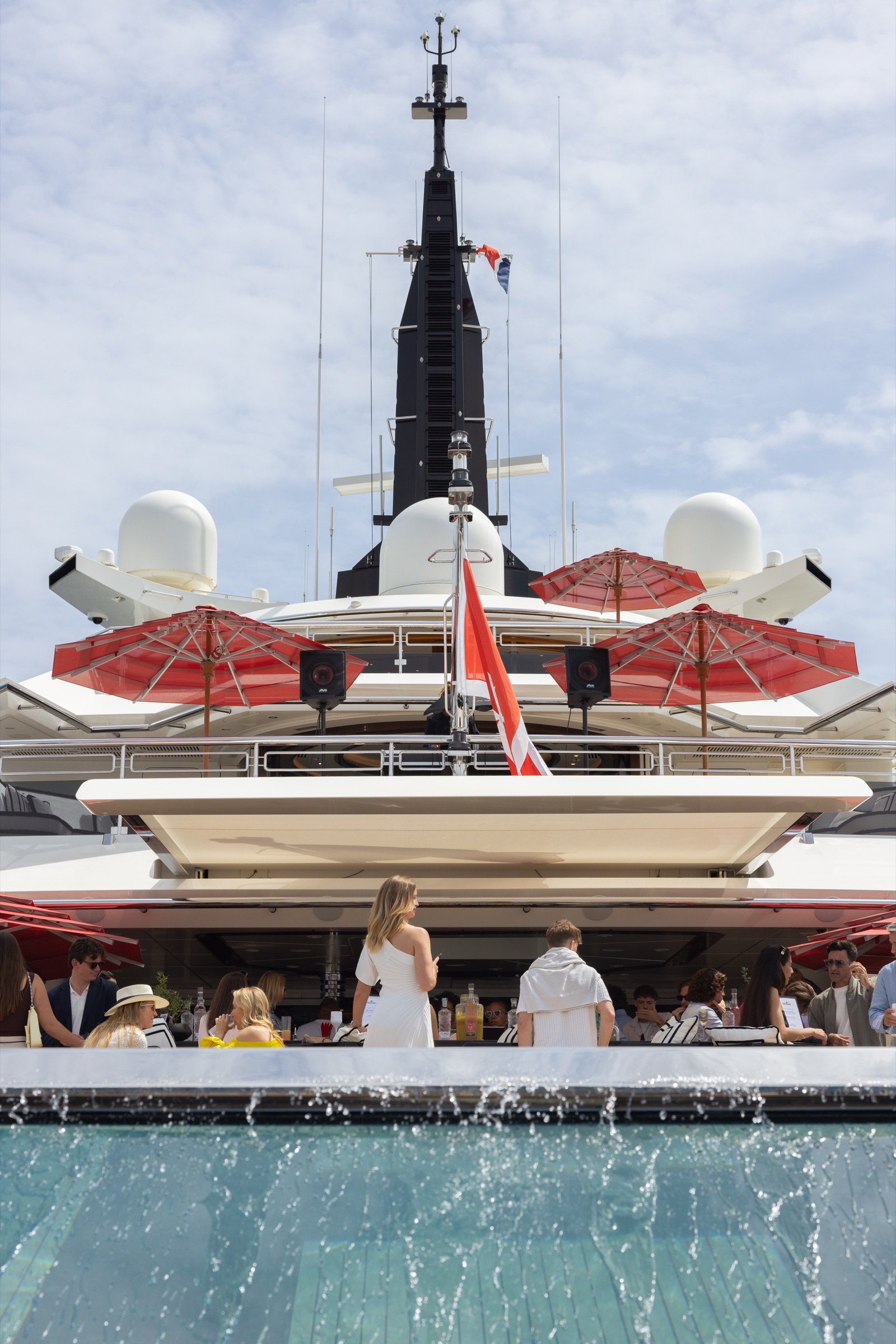 Guests gathered on ALFA NERO’s aft decks and pool during the Ocean Bottle evening at Cannes