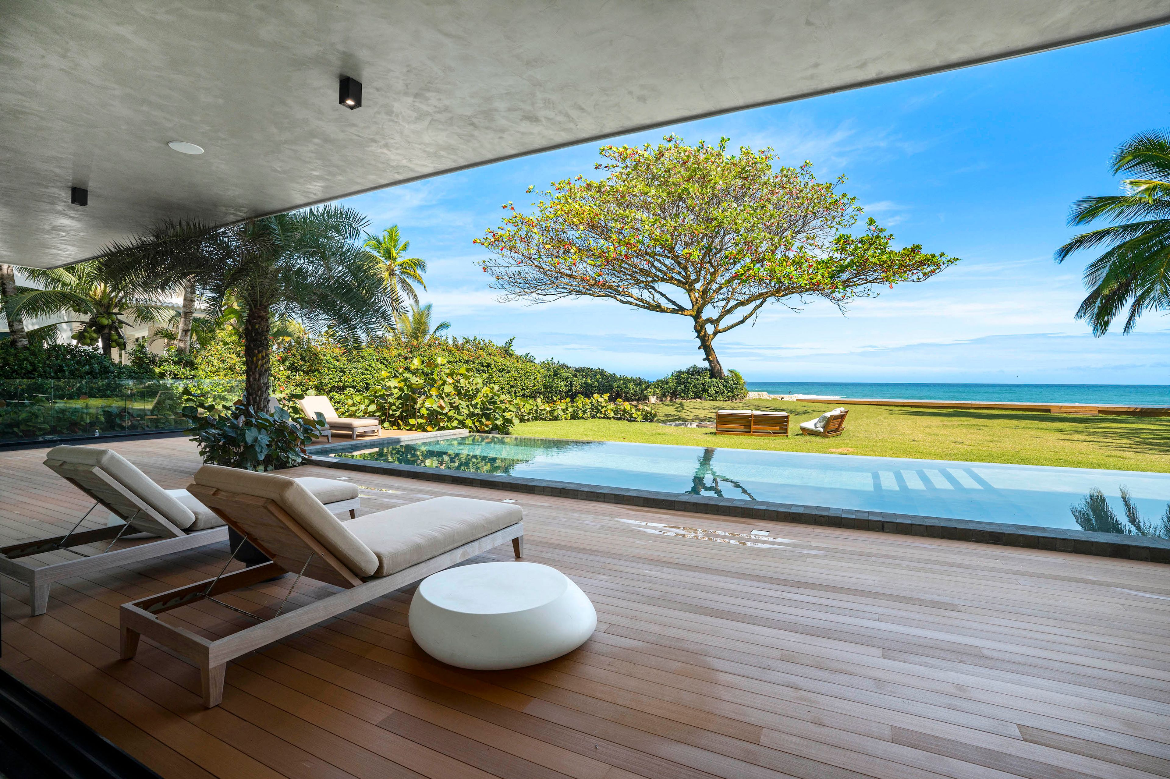 Pool terrace with direct and private beach access at Villa Roge