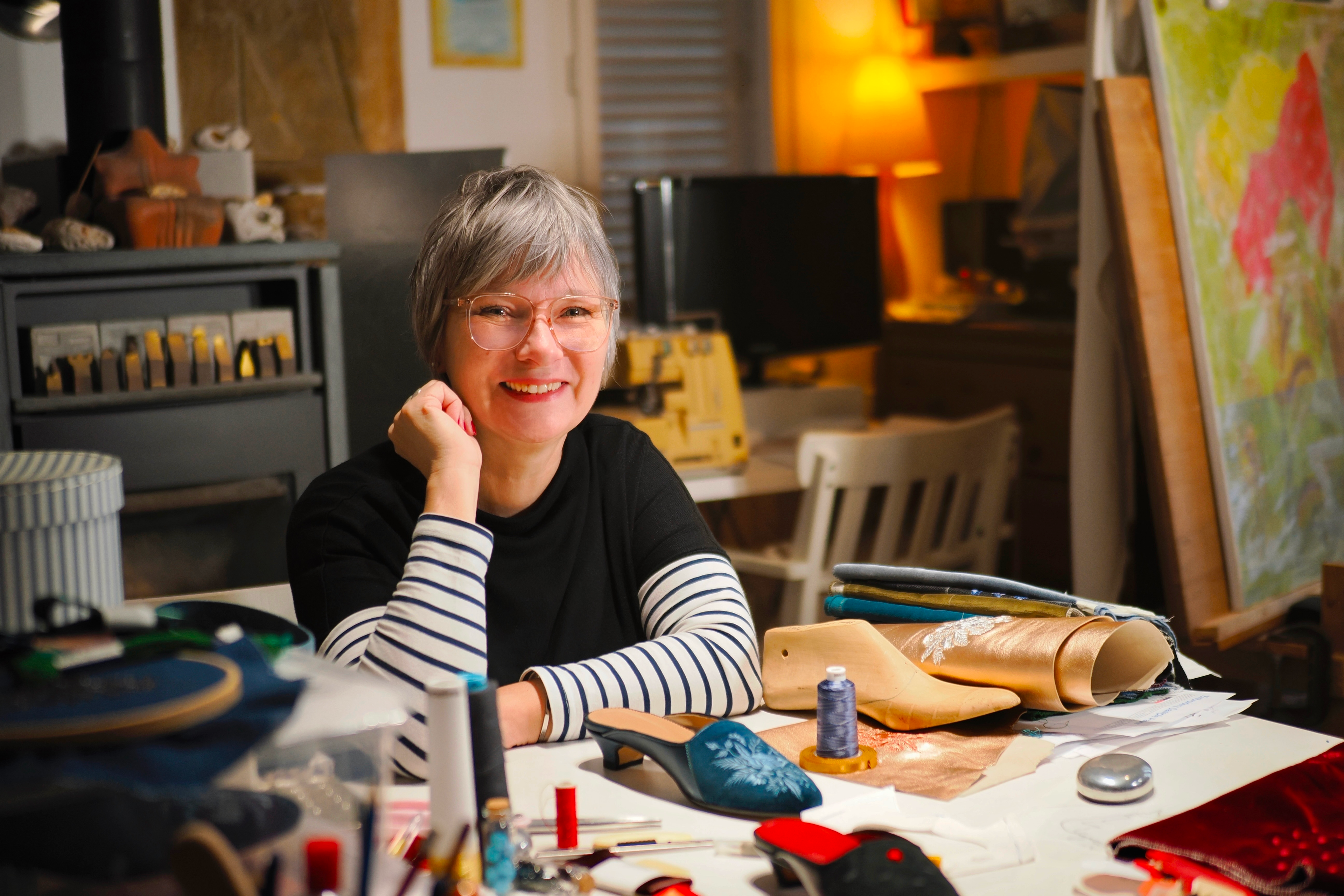 woman at desk in her art studio