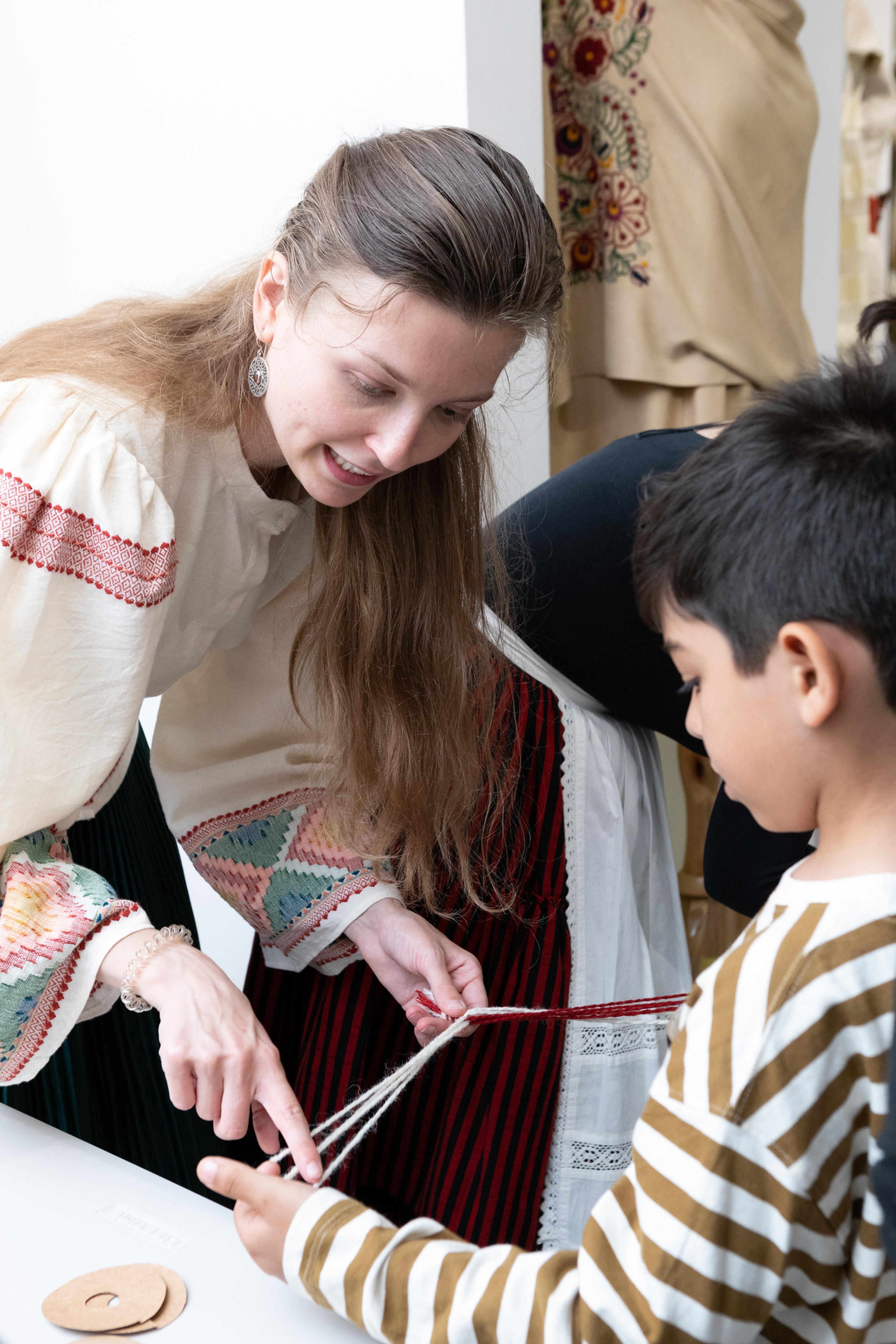 woman and young boy playing with string